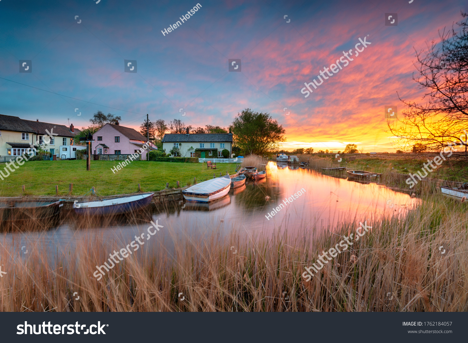 Stunning sunset over the village green and boats on the river at West Somerton in the Norfolk Broads #1762184057