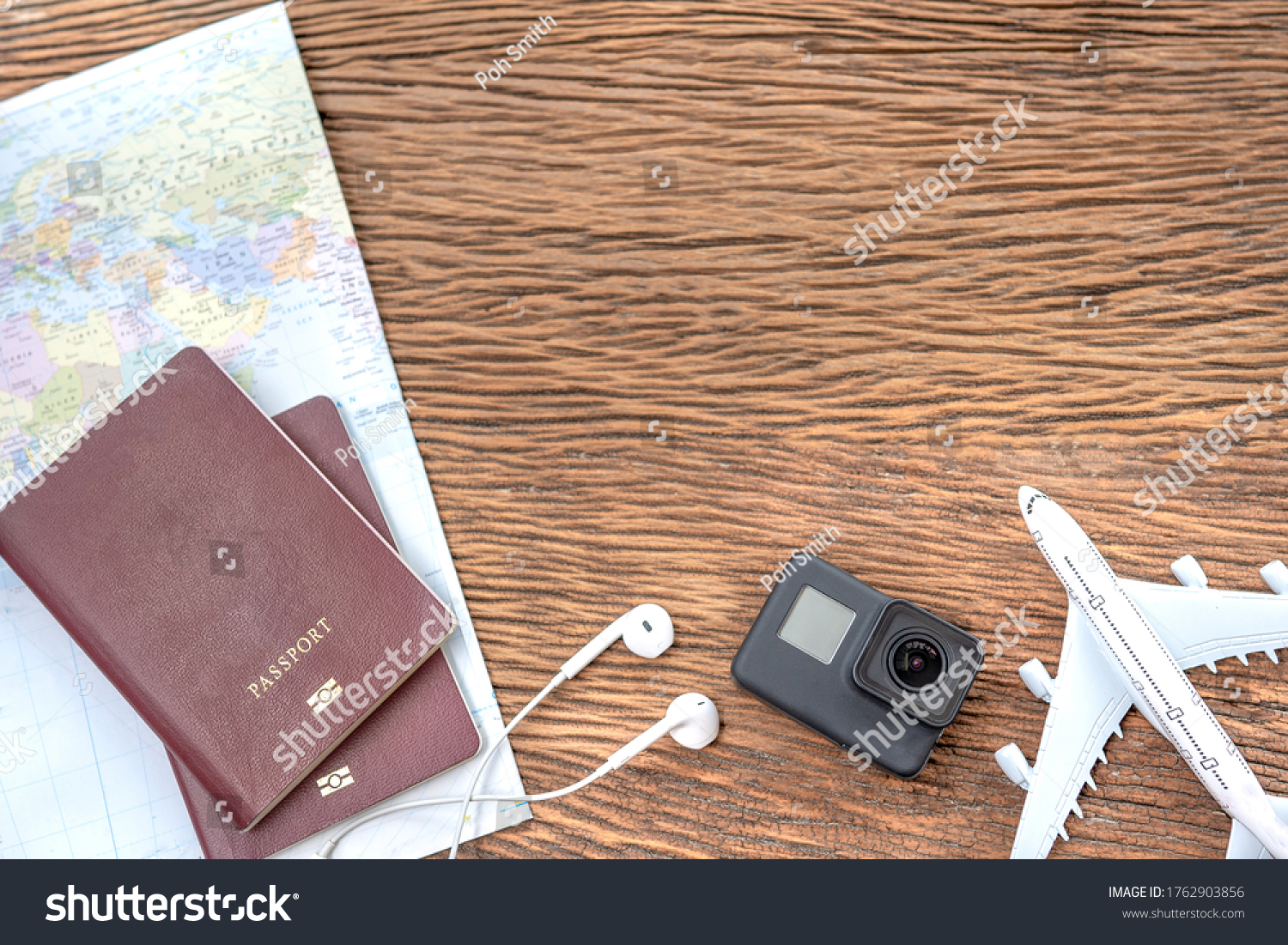 Passport with a map on old wooden background.Travel planning.Top view of traveler accessories with a camera, plane on world map.Preparation for travel.Traveling Journey Vacation Holiday concept. #1762903856