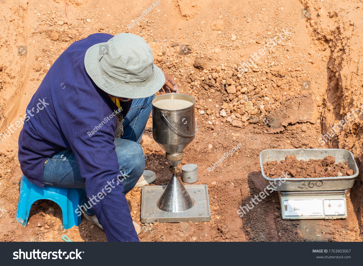 Worker using equipment for testing laboratory field density test sand cone method and soil density test of road under the construction.Soil field density test sand cone method calculation . #1763803067