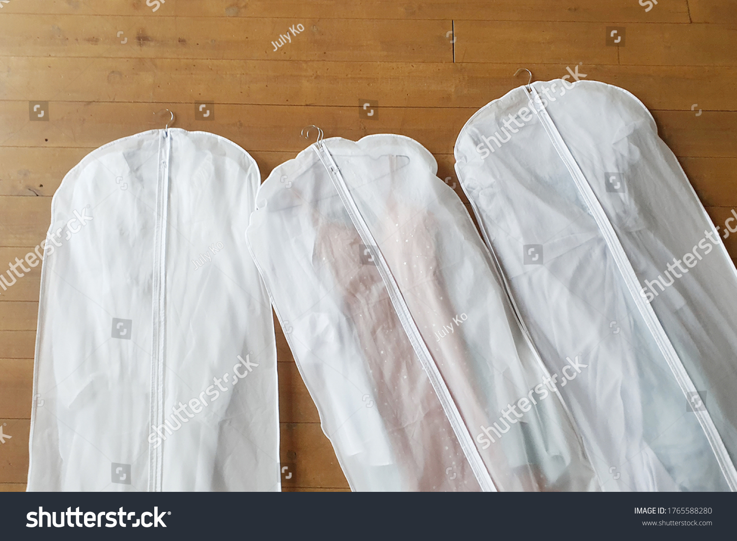 Three white Hanging Garment Bag on the floor. The morning before the wedding. Pack your things on a trip or sort and hang up your wardrobe. #1765588280