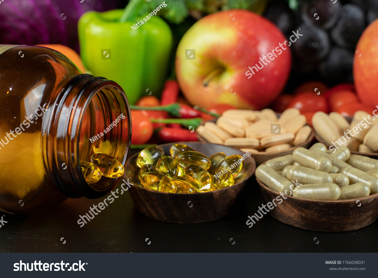 Glass of bottle with food supplement on fruits and vegetables background . Health concept. #1766038031
