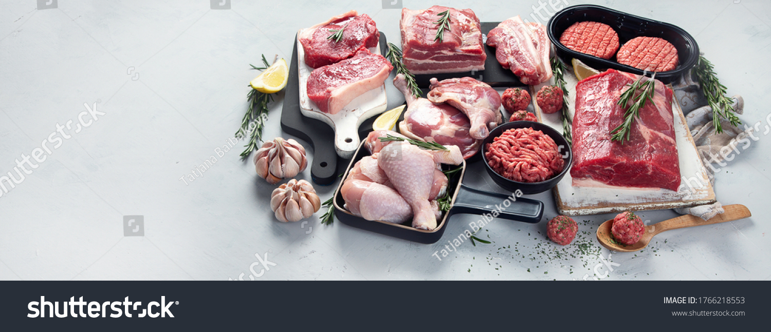 Assortment of raw meats on grey background. Panorama, banner with copy space #1766218553