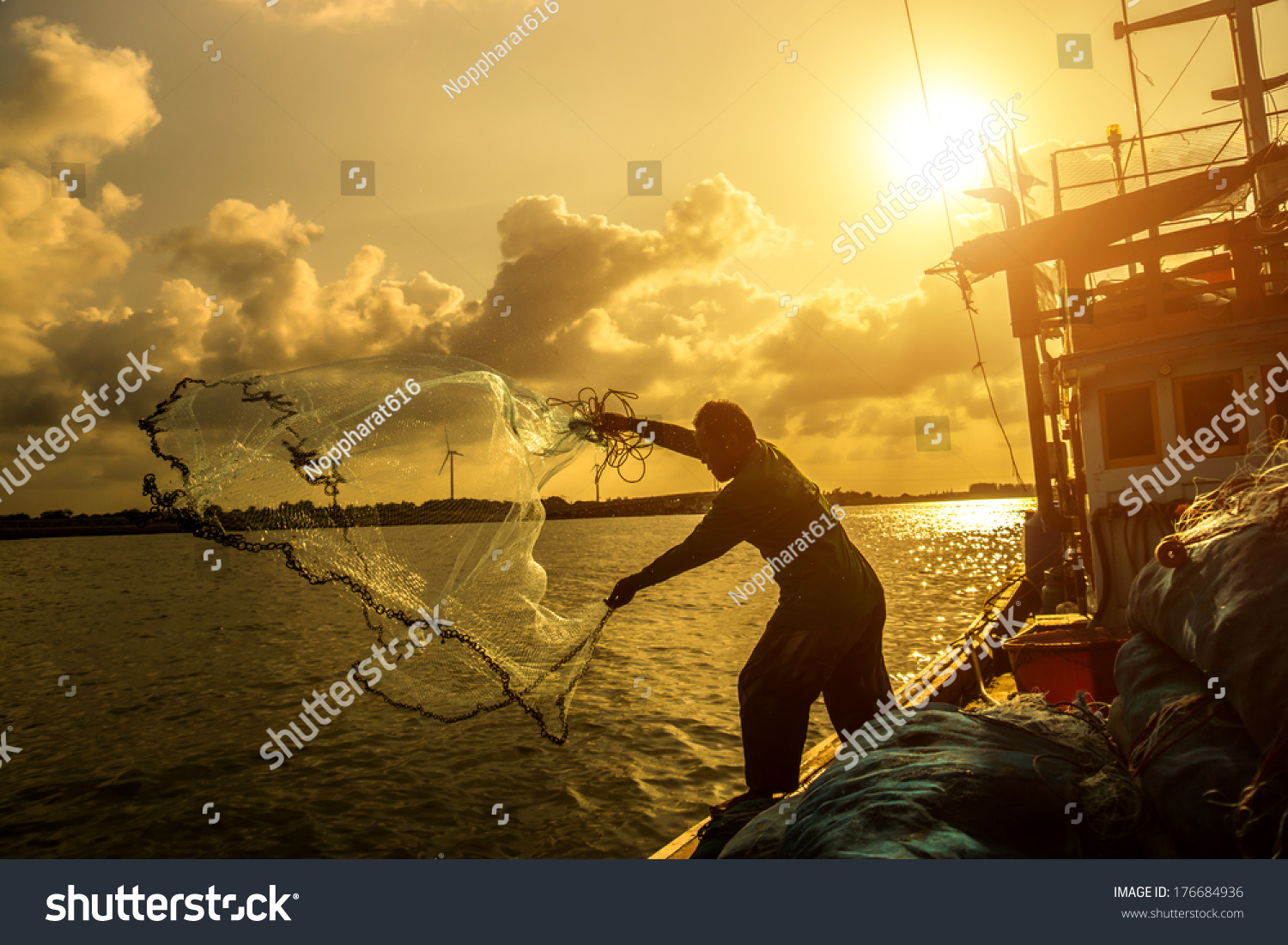 Silhouettes fisherman casting on a crab boat. #176684936