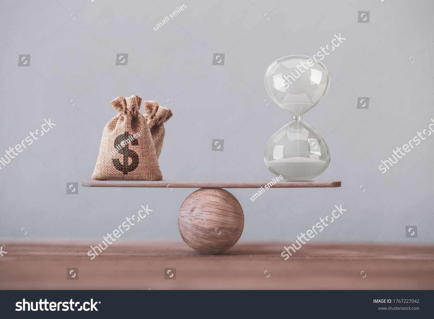 Write sand clock or hourglass and dollar bagson a balance scale in equal position on wood table. Financial concept : Time value of money, asset growth over time, depicts investment in long-term equity #1767227042