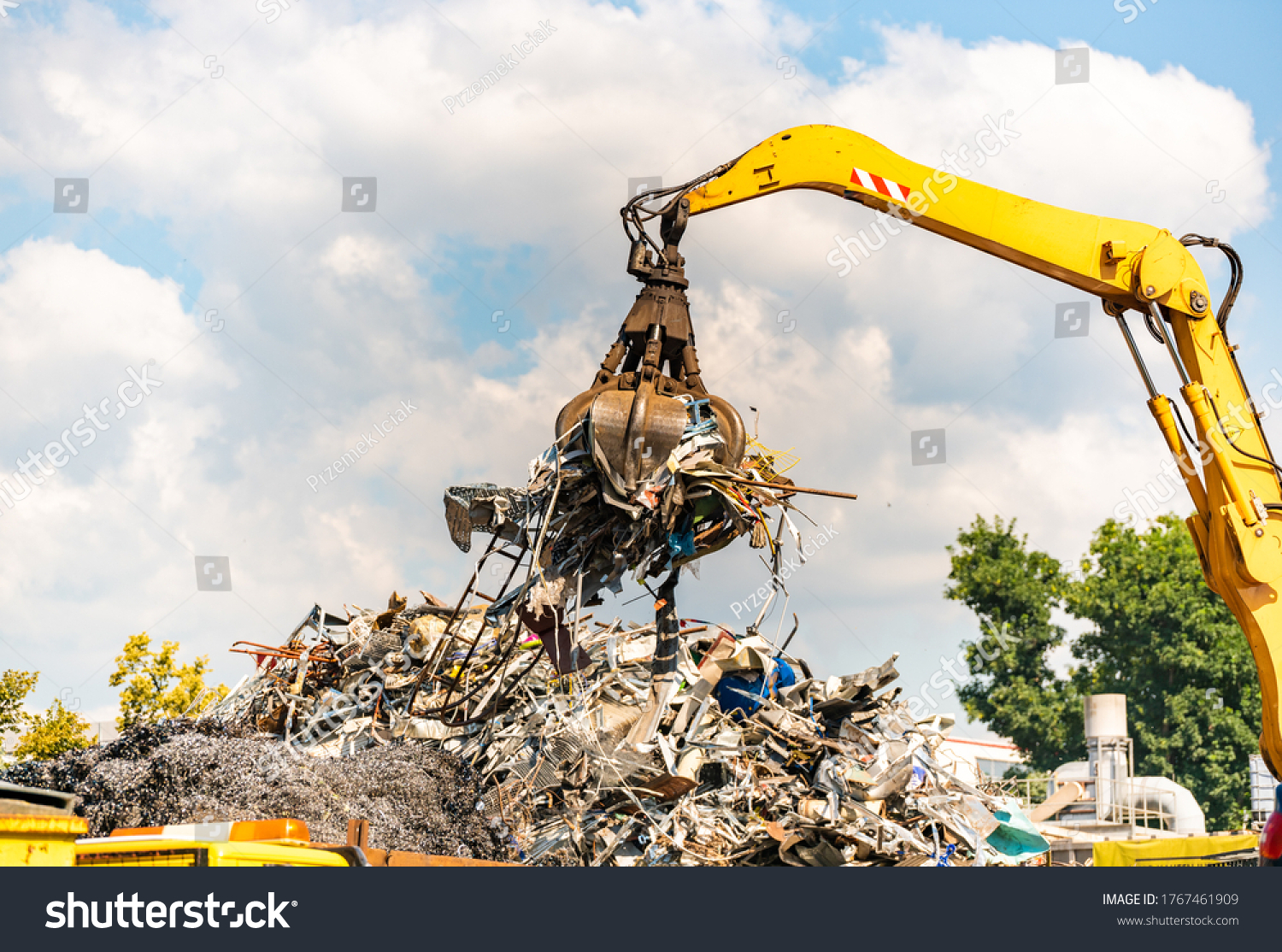 Close-up of a crane for recycling metallic waste on scrapyard #1767461909