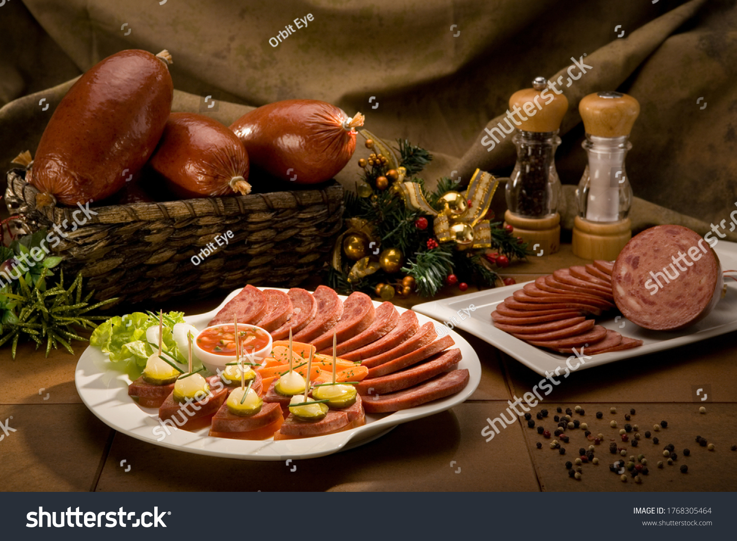 Still life of many and different food products, such as ham, salami, carrots, pickles and sauces, with some Christmas decorations. #1768305464