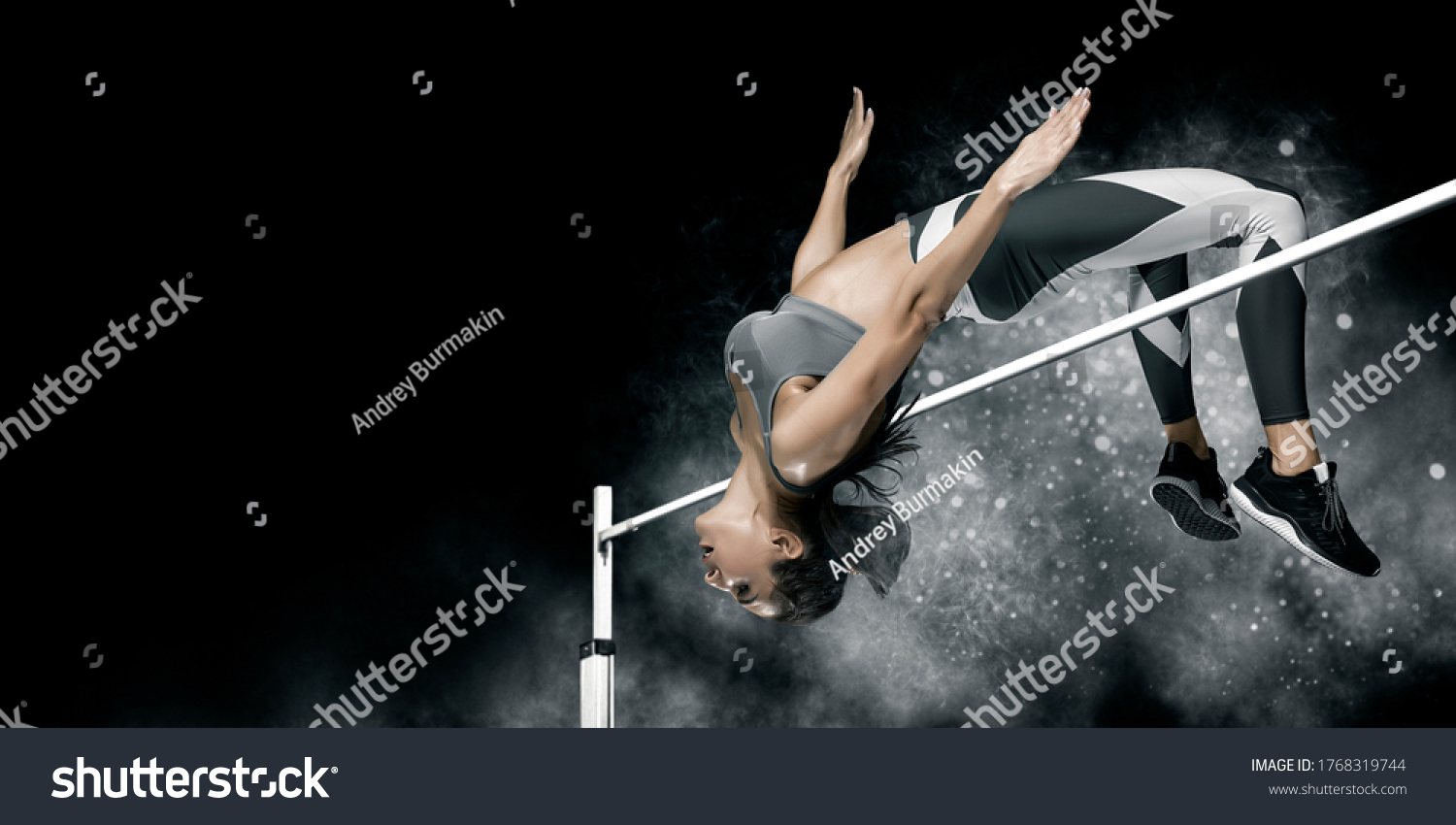Woman in action of high jump on smoke background. Sports banner. Horizontal copy space background #1768319744