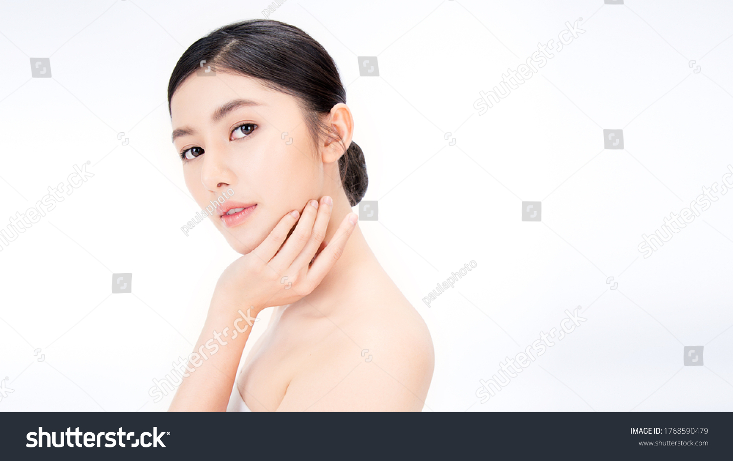 Closeup portrait of beauty asian woman with fair perfect healthy glow skin hand touching shoulder copy space, young beautiful asia girl with pretty smile on face. Beauty korean spa skincare banner