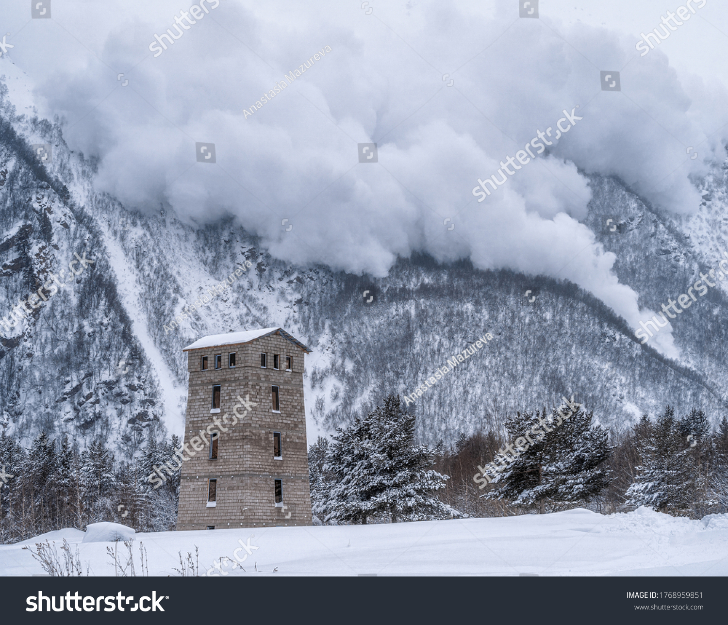 Descent of an avalanche from the mountain. House at the foot of the mountain. Winter mountain landscape. #1768959851