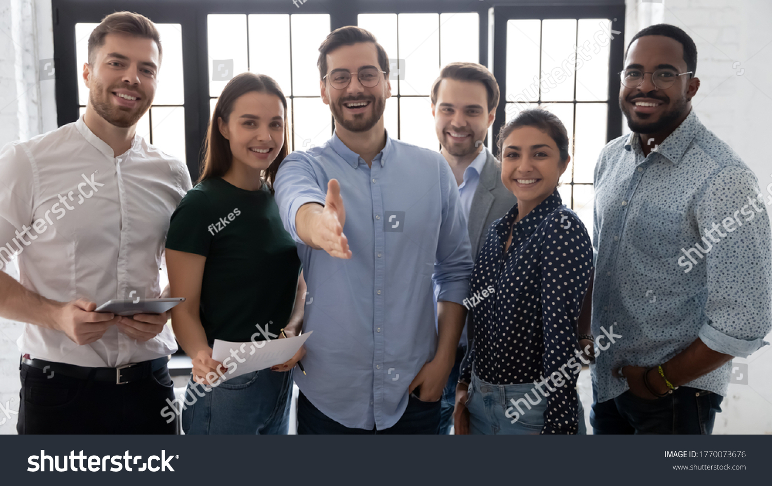 Millennial male leader stretch out his hand for handshake welcoming new employee invites newcomer to corporate team, group showing amity, human resources, boss greets clients express respect concept #1770073676