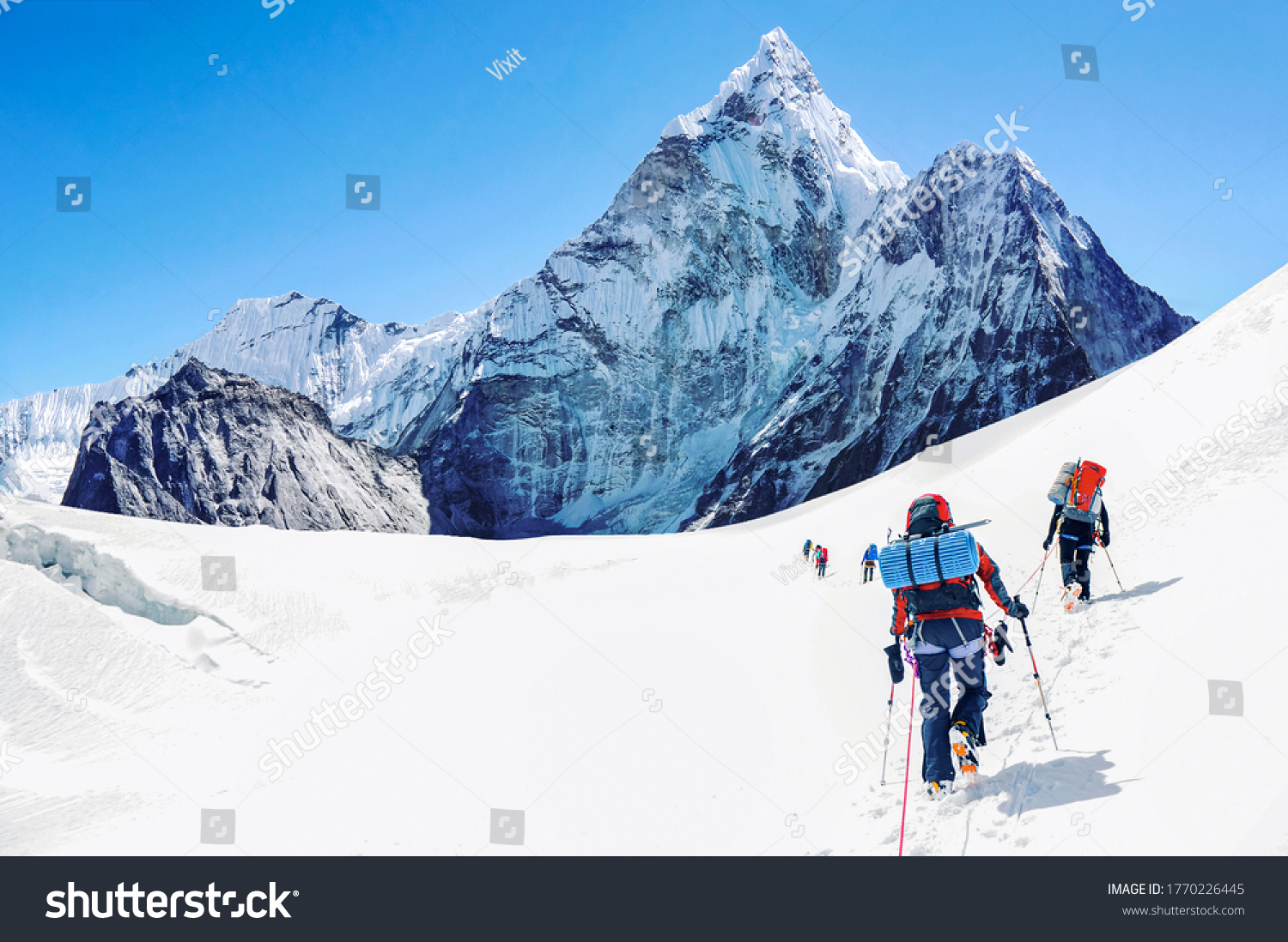 Group of climbers reaching the Everest summit in Nepal.  #1770226445