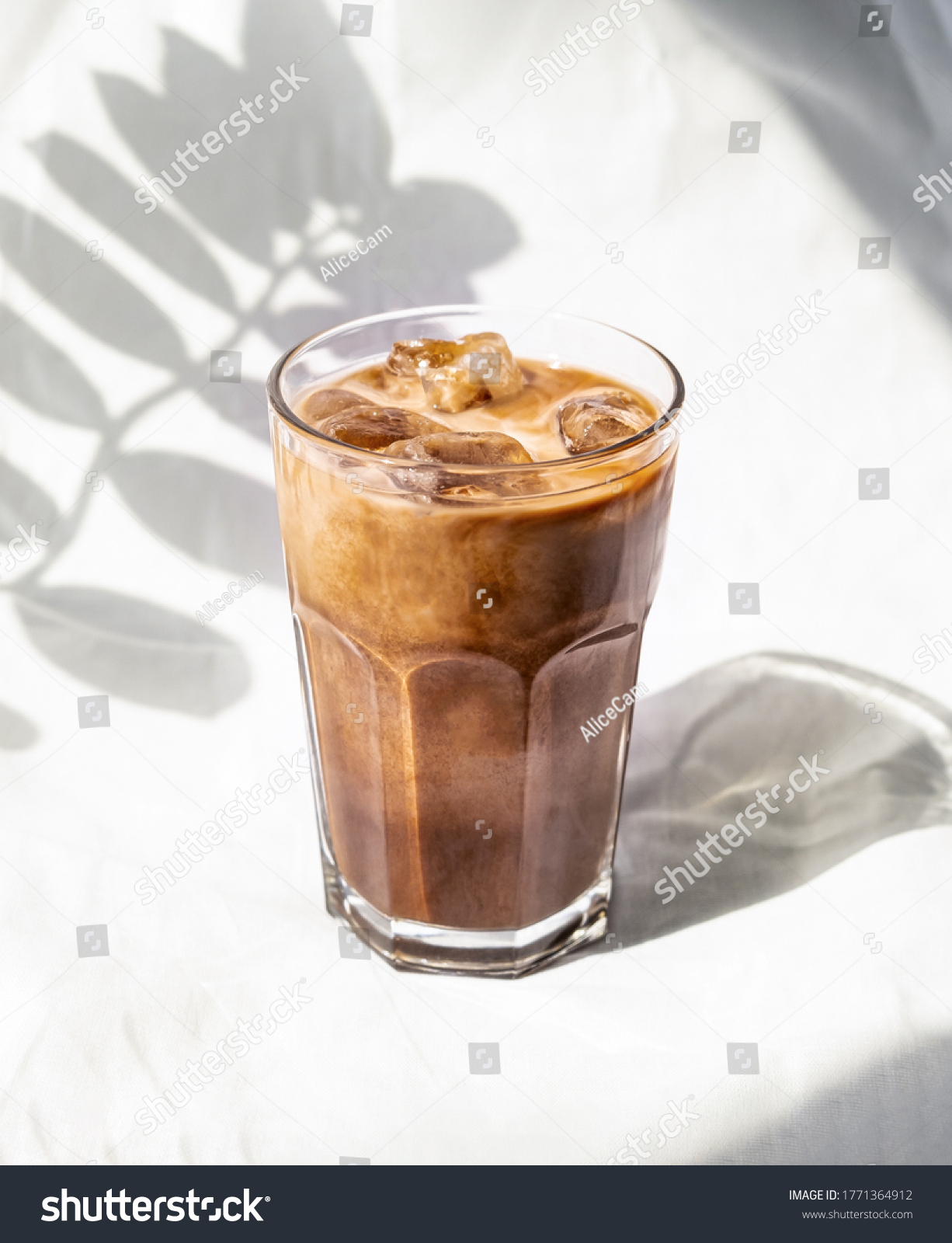 Milk cream iced cold brew coffee. Summer coffee cold drink cocktail with ice and milk. Aesthetic, minimalism. #1771364912