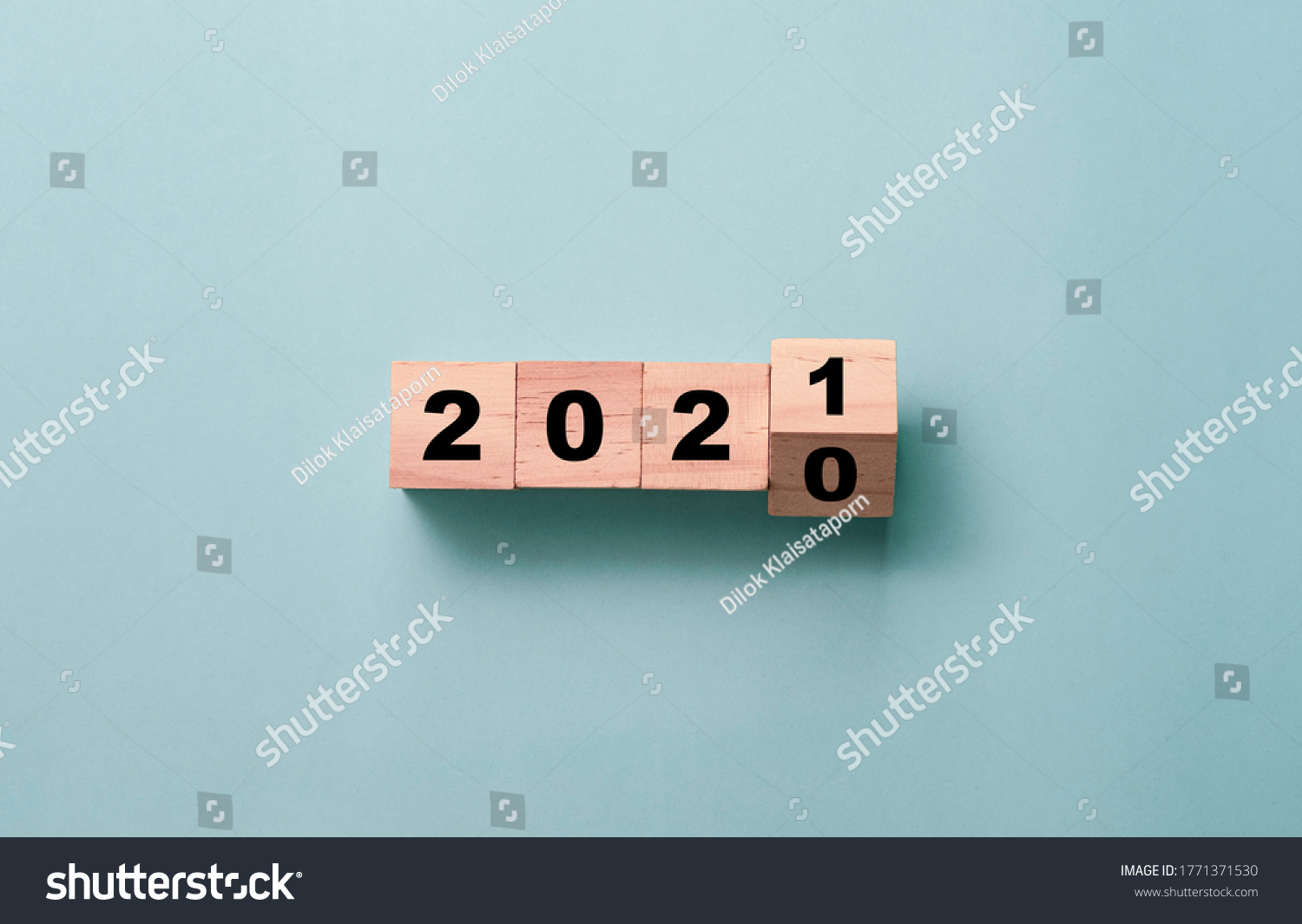 Flipping of wooden cubes block to change 2020 to 2021 year. Merry Christmas and happy new year concept. #1771371530