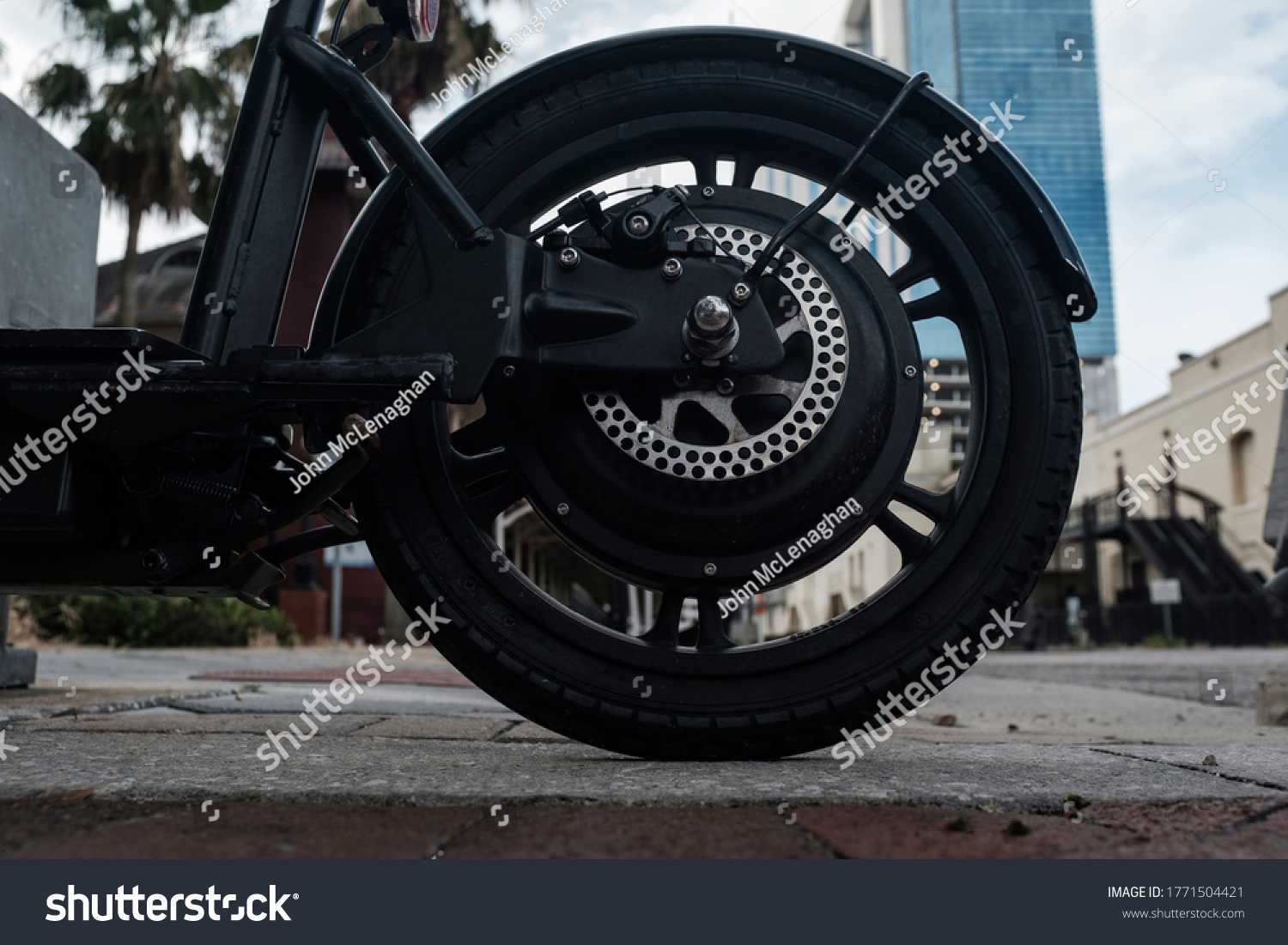 Black Rubber Tire On A Motor Scooter Downtown #1771504421