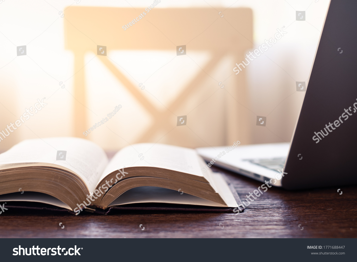 Workplace indoor with book or Holy Bible and laptop on the wooden desk #1771688447