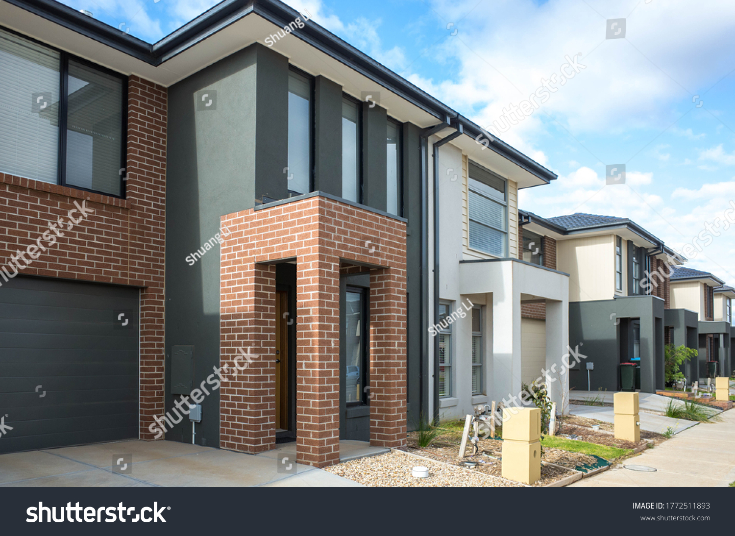 Building of some residential townhouses in a suburb of Australia. The exteriors of some two-story modern Australian suburban homes.  #1772511893