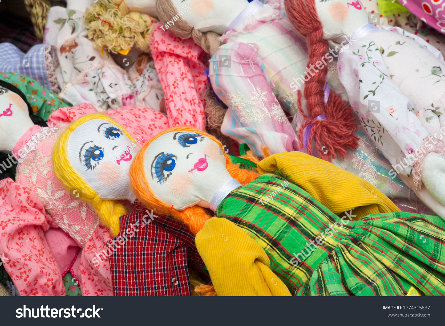 Flea market,  folk crafts. Handmade rag dolls. A rag doll is a children's toy. It is a cloth figure, a doll traditionally home-made from (and stuffed with) spare scraps of material. #1774315637