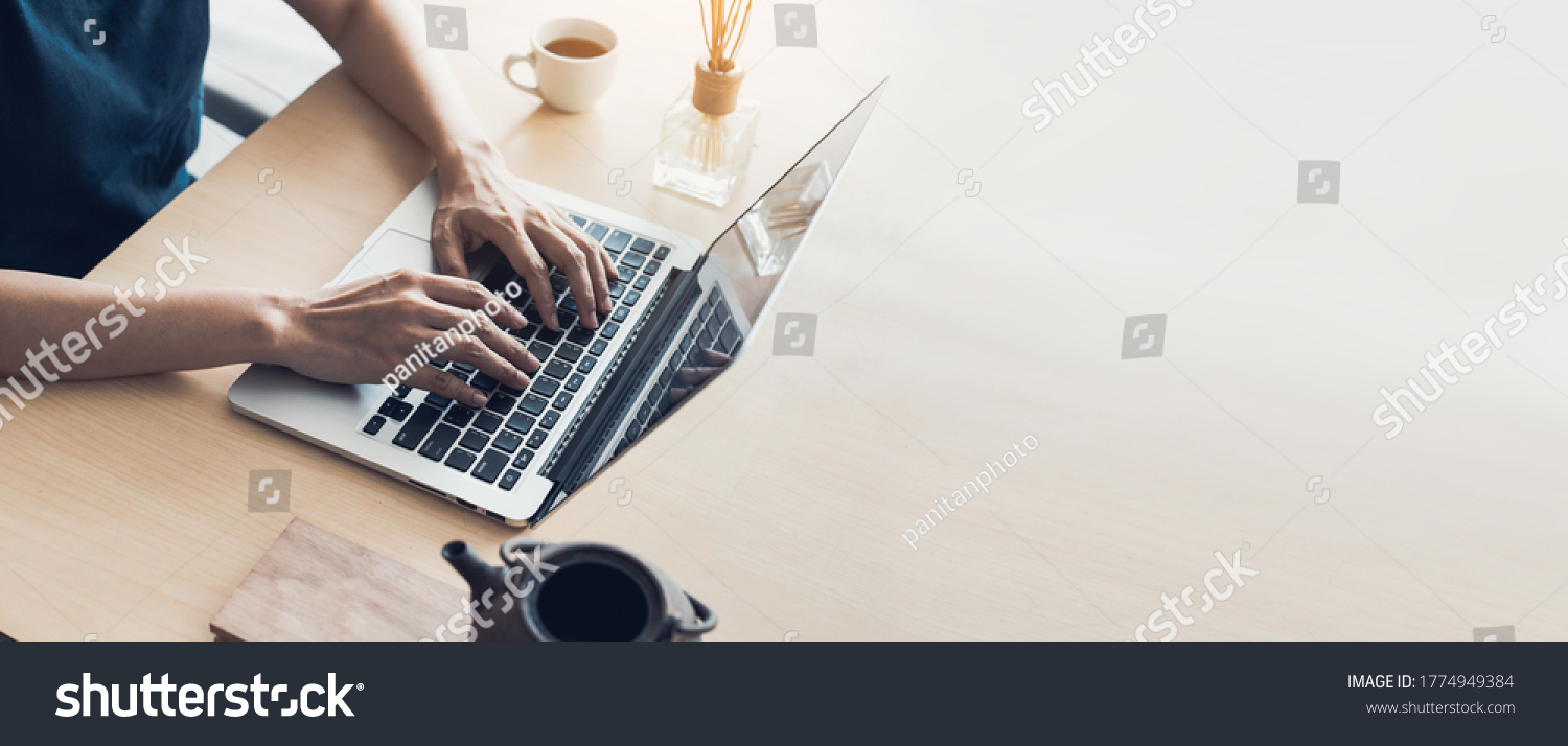 using computer.hand typing keyboard laptop online chatting search form internet while working sitting at coffee shop.concept for.technology device contact communication business people #1774949384