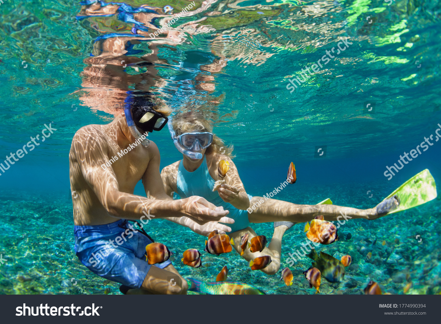 Happy family vacation. Young couple in snorkeling mask hold hand, dive underwater with fishes in coral reef sea pool. Travel lifestyle, watersport adventure, swim activity on summer beach holiday #1774990394