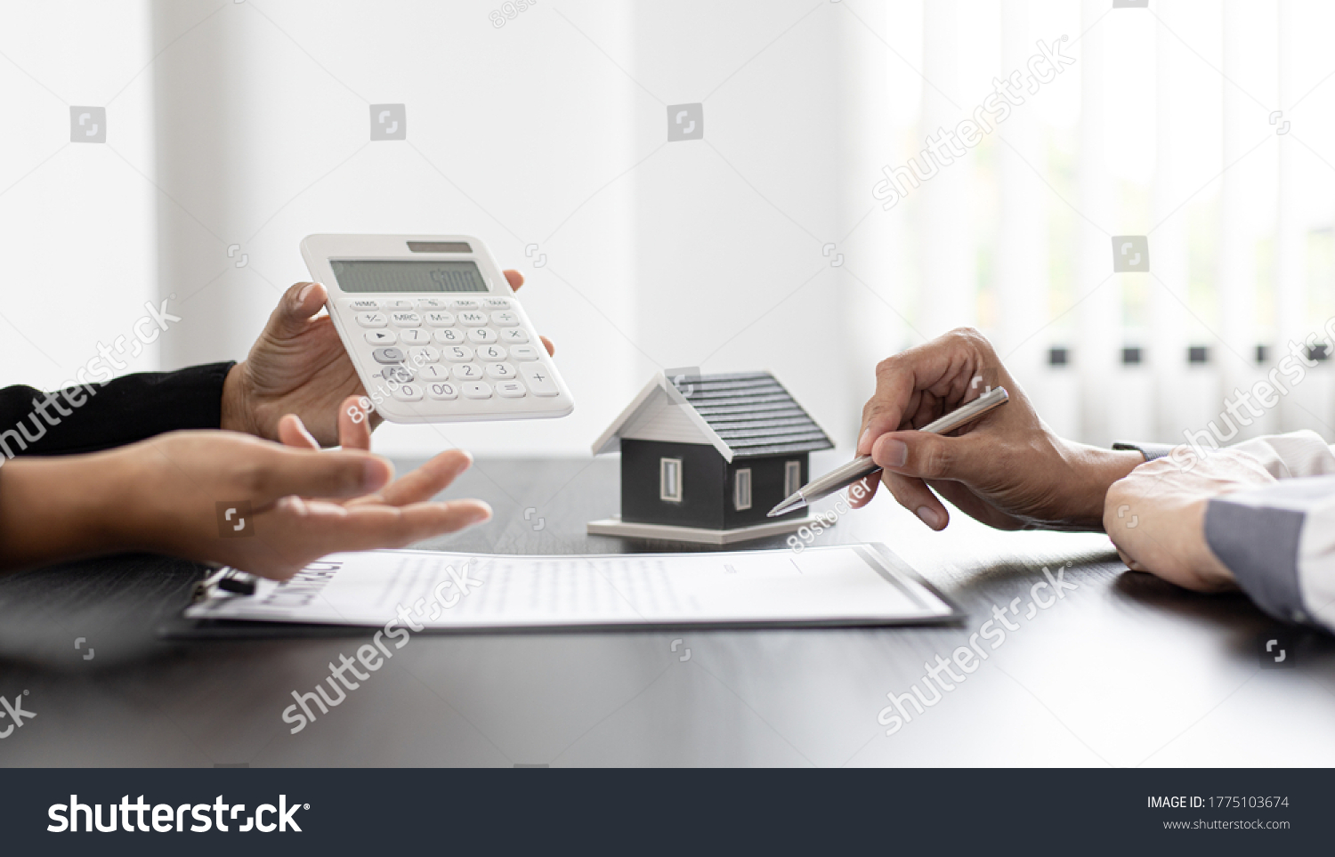 Real estate agent talked about the terms of the home purchase agreement and asked the customer to sign the documents to make the contract legally, Home sales and home insurance concept. #1775103674
