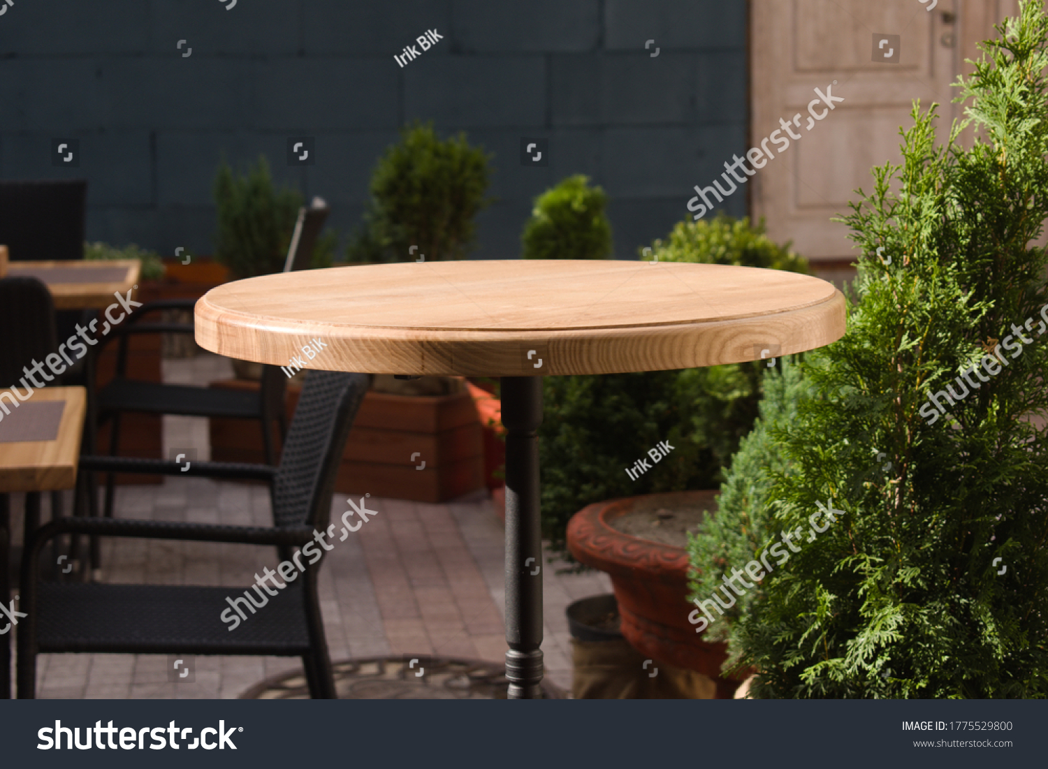 wooden round table in open air cafe #1775529800