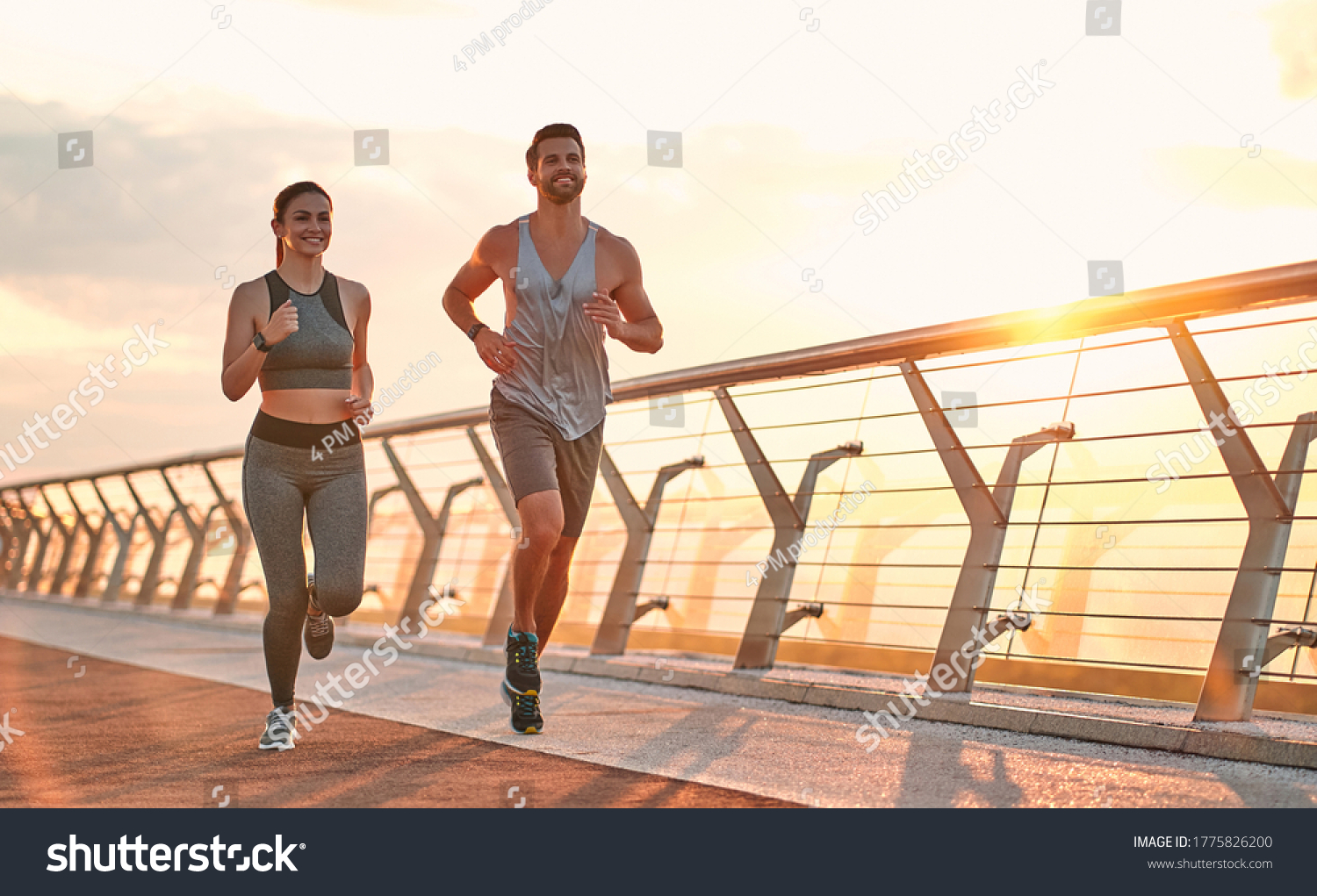 Couple doing sport together on the street. Morning run #1775826200