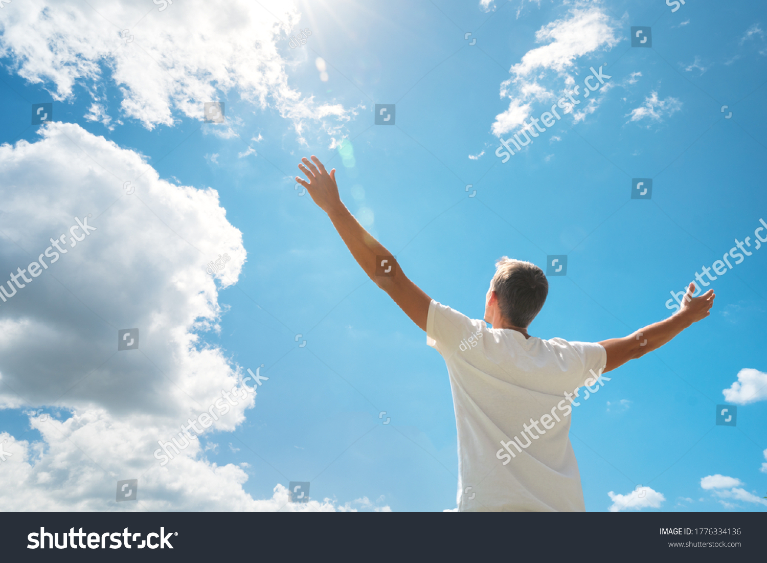 Man strive hands to the deep blue sky and sun. Religion and conceptual scene. Worship to God.  #1776334136