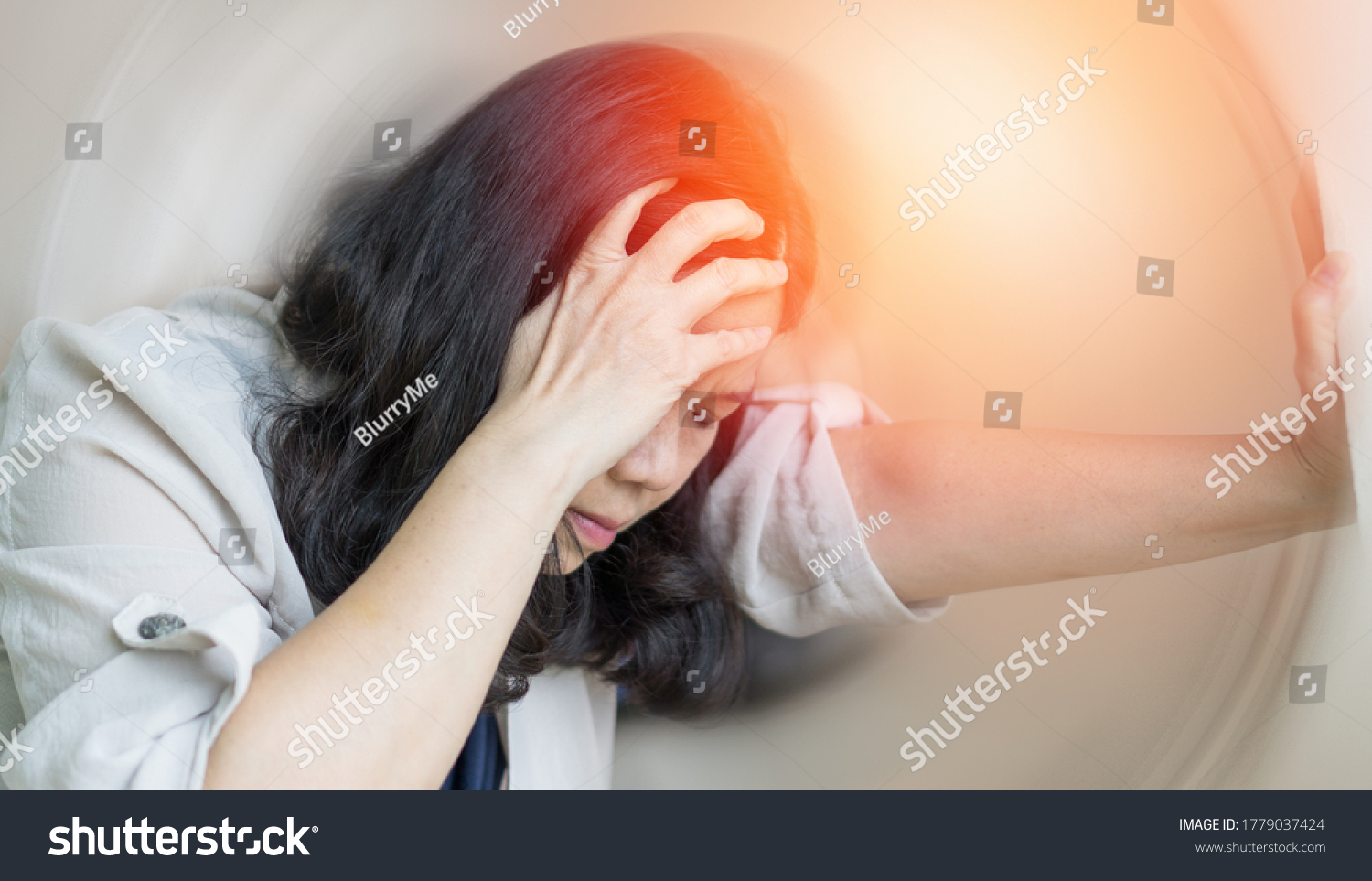 Vertigo illness concept. Woman hands on his head felling headache dizzy sense of spinning dizziness,a problem with the inner ear, brain, or sensory nerve pathway. #1779037424