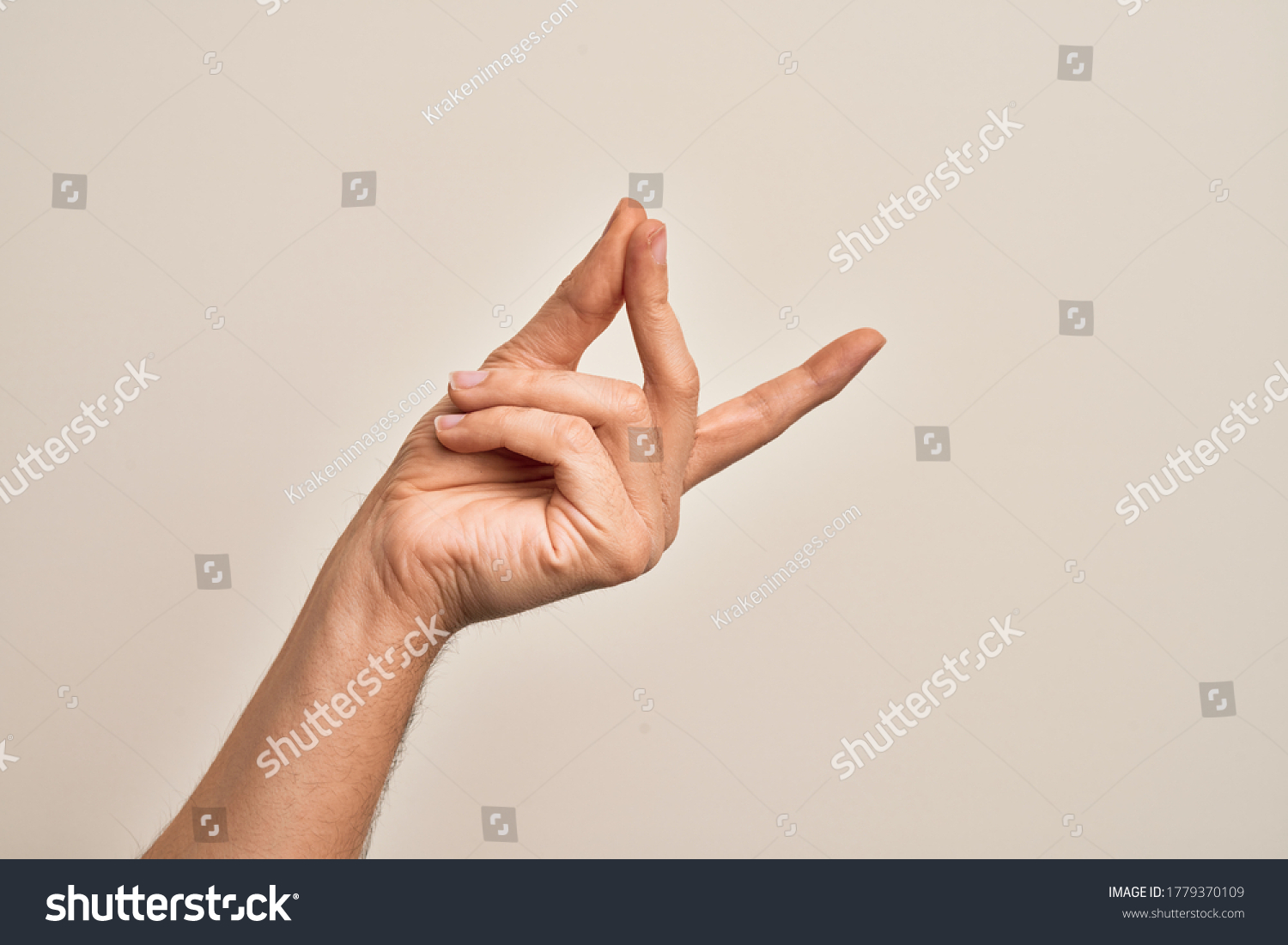 Hand of caucasian young man showing fingers over isolated white background snapping fingers for success, easy and click symbol gesture with hand #1779370109