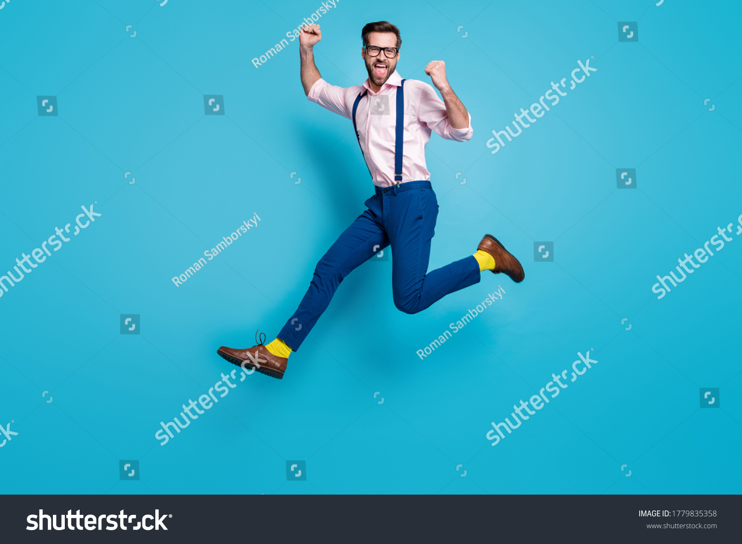Full body profile photo of handsome man jump high up running competition work worker raise fists first place winner wear specs shirt suspenders pants boots isolated blue color background #1779835358