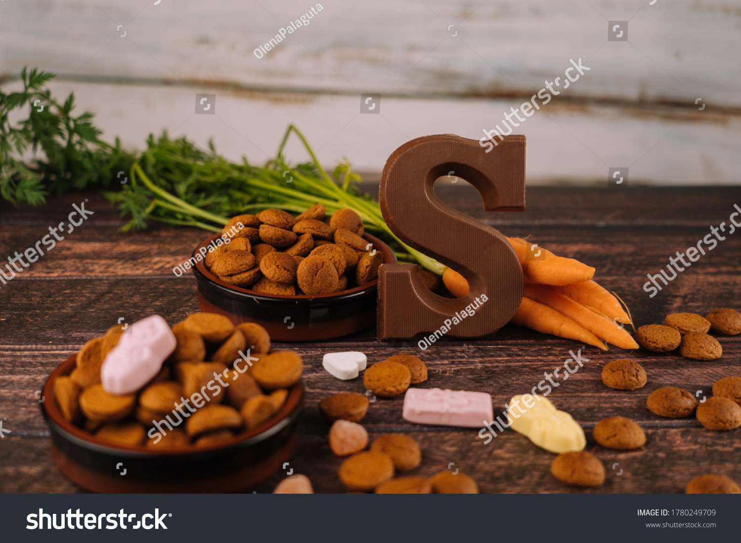Dutch holiday Sinterklaas. Background with traditional food - pepernoten, chocolate letter, sweets strooigoed and carrots for horse. Concept for children party in Saint Nicolas day five december #1780249709