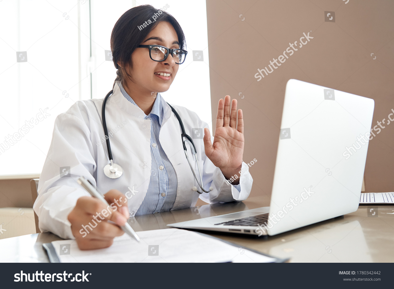 Indian female doctor talk with patient make telemedicine online webcam video call. Female physician therapist videoconferencing on computer in remote telemedicine laptop virtual chat. Telehealth. #1780342442