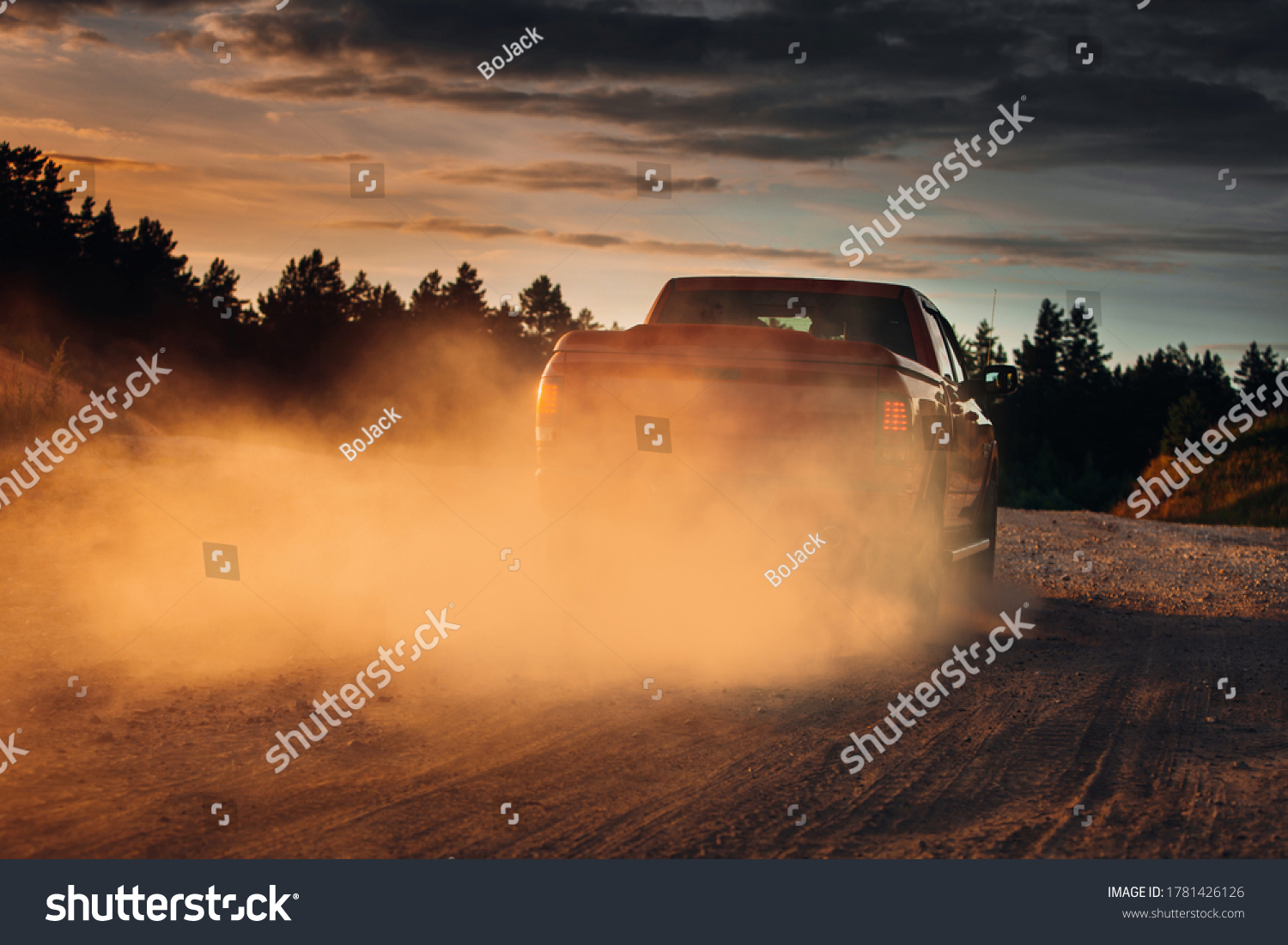 Pickup truck car in motion at country road with clouds of dust #1781426126
