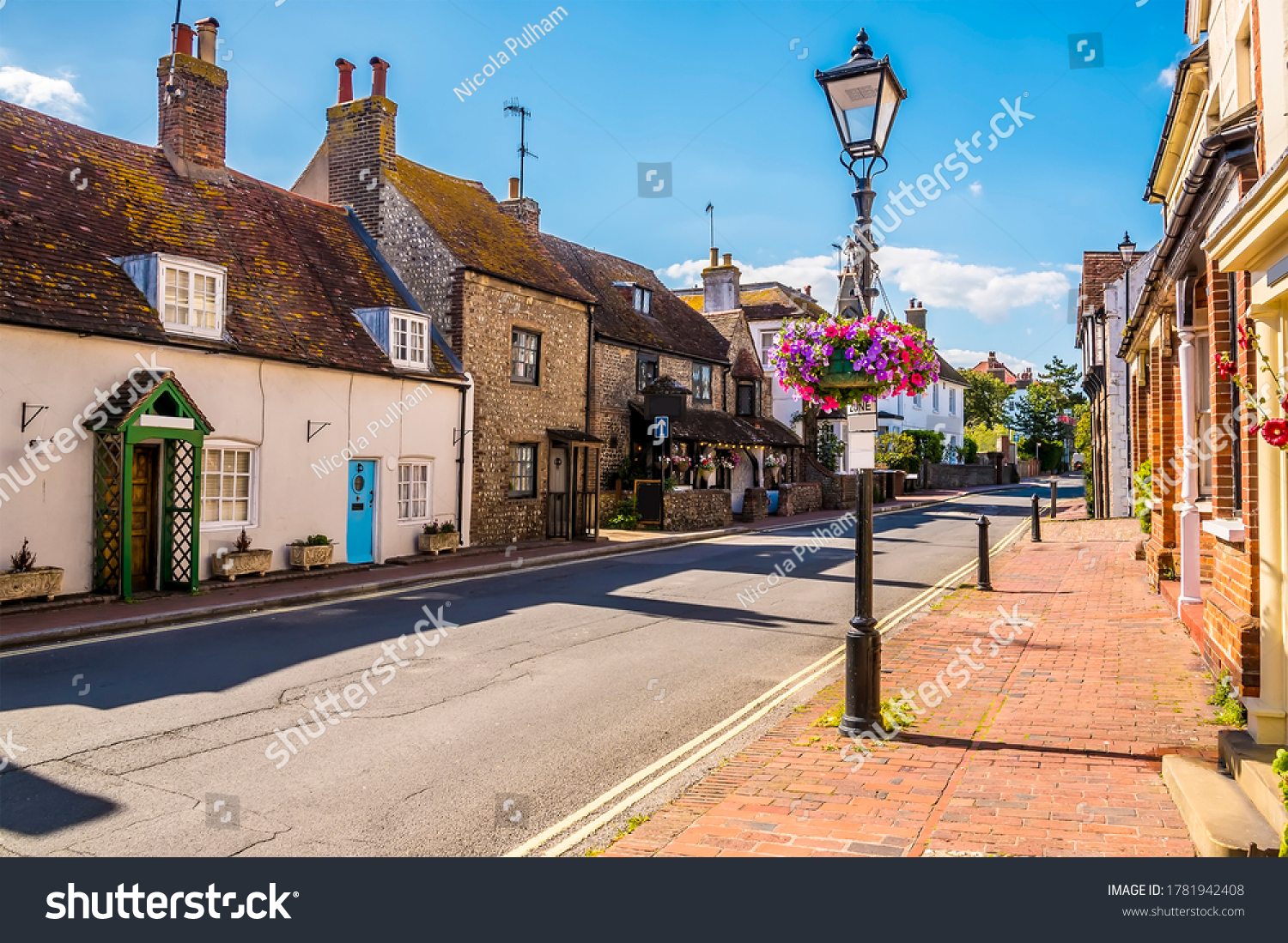 A view up the traditional High Street in the town of Rottingdean, Sussex, UK in summer #1781942408