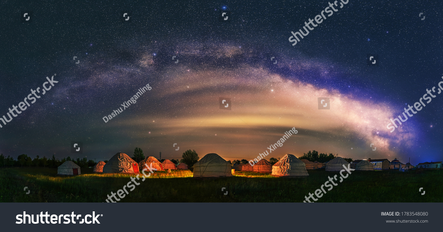 Under the bright Milky Way, Mongolia yurts on the grassland are scattered.	
 #1783548080