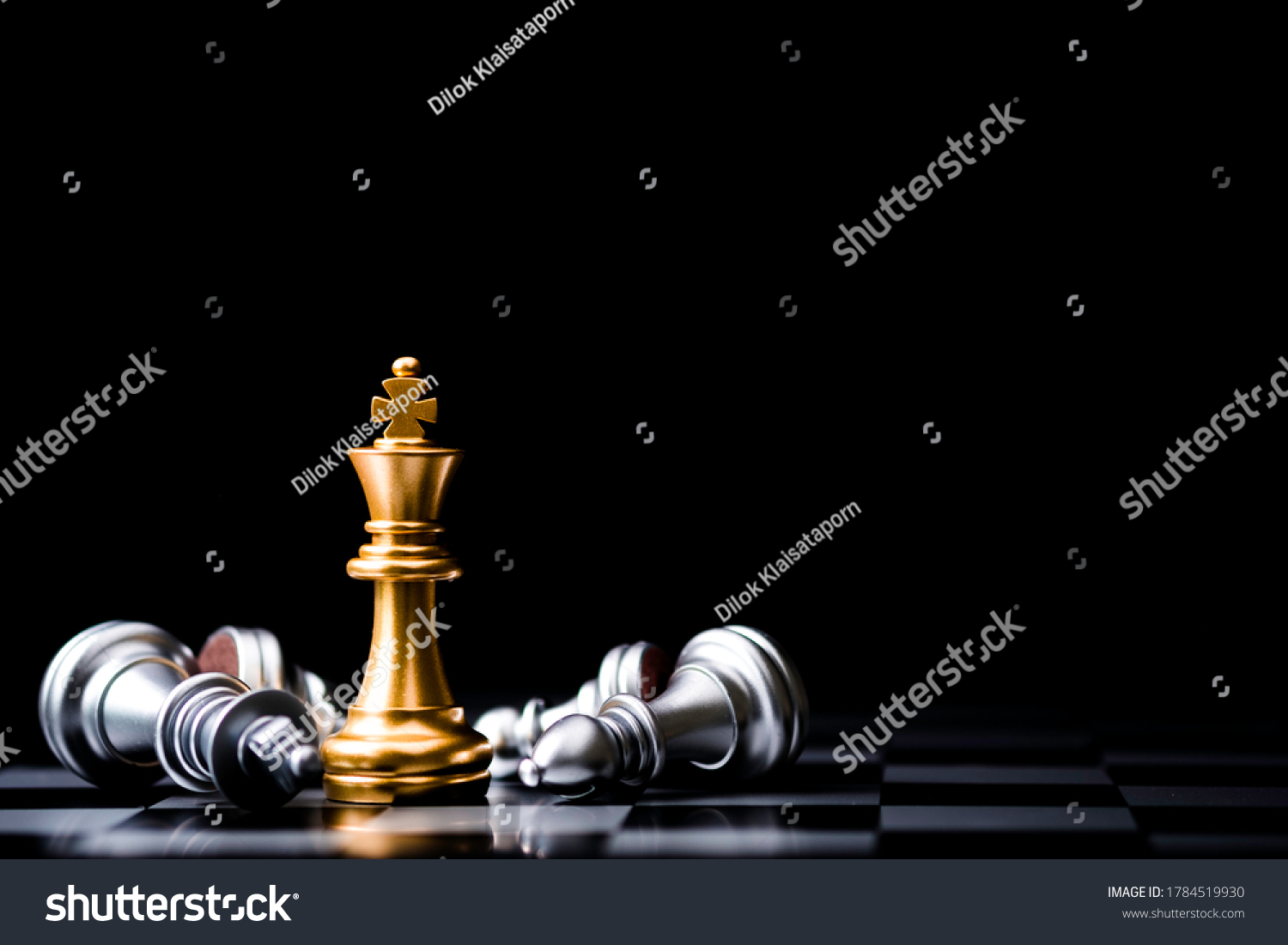 Stand of golden king chess and fallen silver king chess. Winner of business competition and marketing strategy planing concept. #1784519930