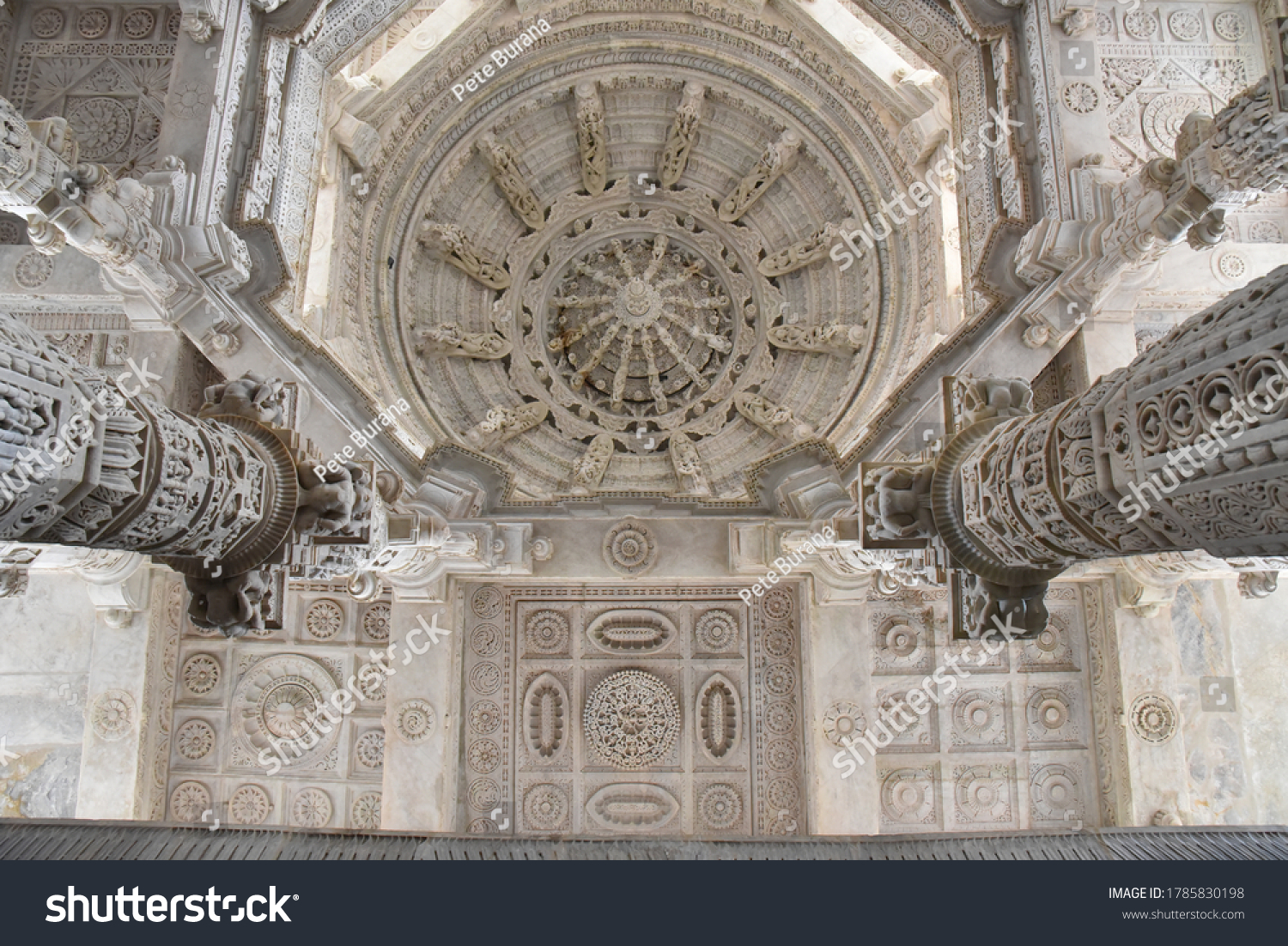 White pink marble stone carvings of ceiling of Jain temple mandir depicting religious murals in Ranakpur Chaumukha temple, Rajasthan, India #1785830198