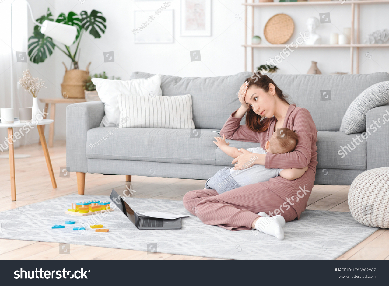 Motherhood Exhaustion Concept. Tired young mom breastfeeding baby and working on laptop at home, feeling frustrated, free space #1785882887