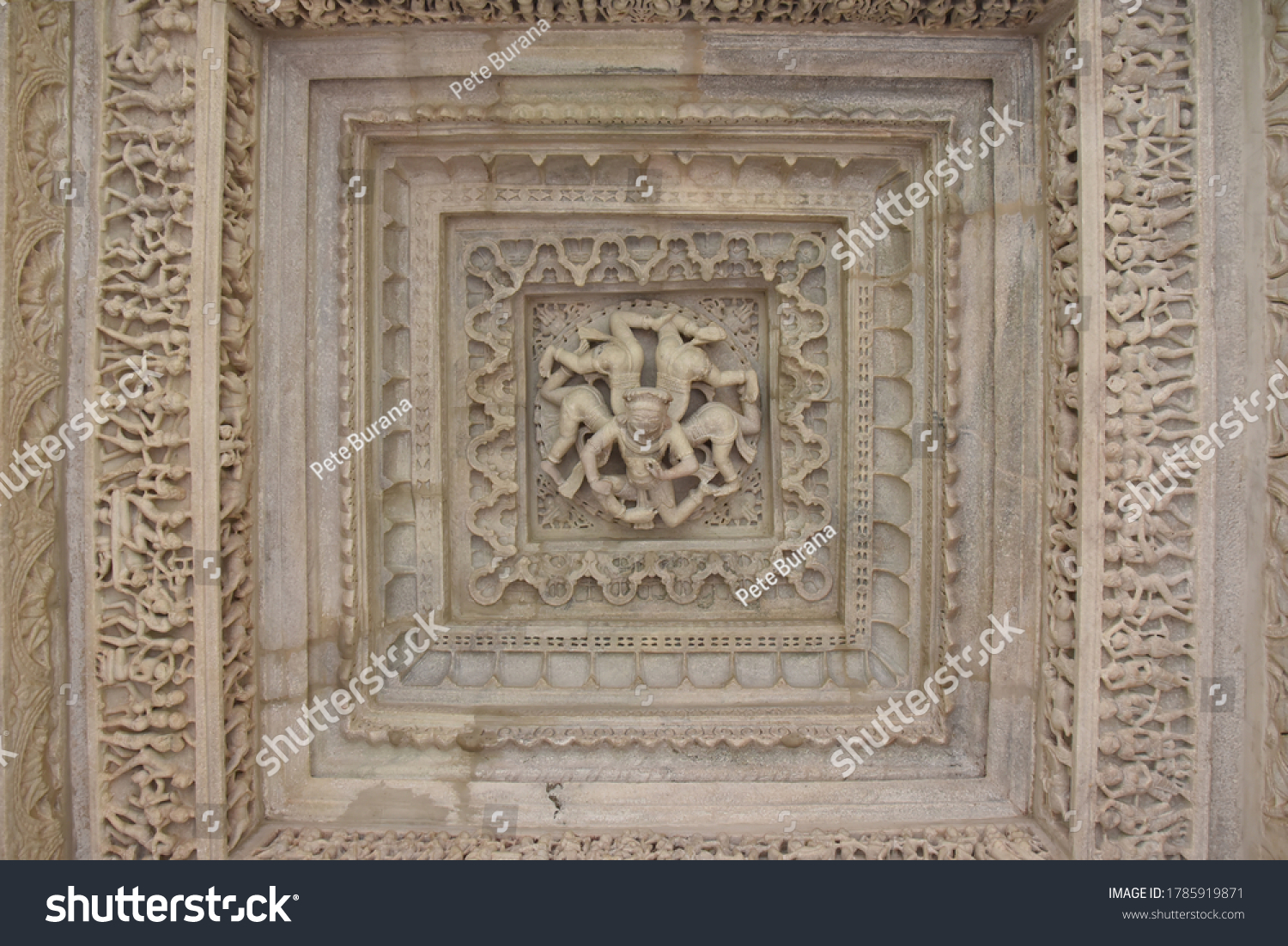 White pink marble stone carvings of ceiling of Jain temple mandir depicting religious murals in Ranakpur Chaumukha temple, Rajasthan, India #1785919871