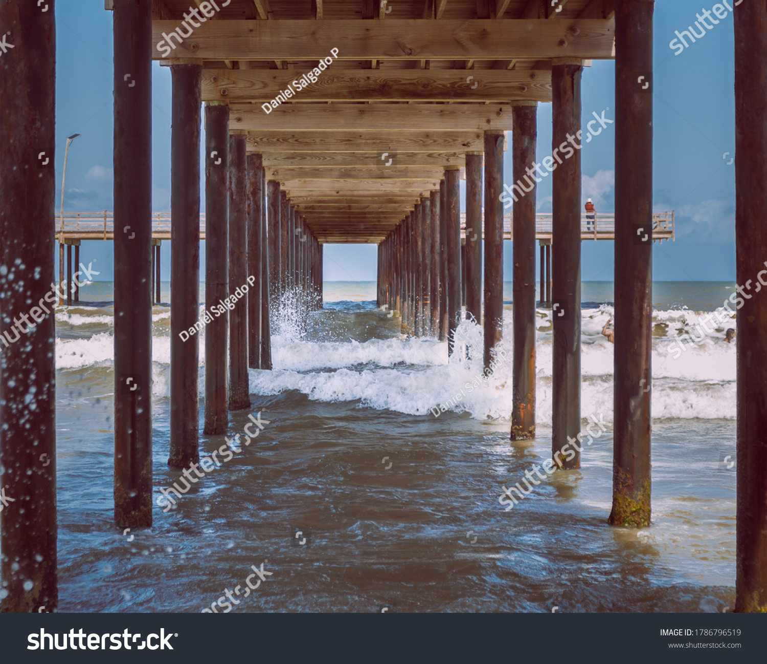 waves under the wooden pier on a clear day
 #1786796519