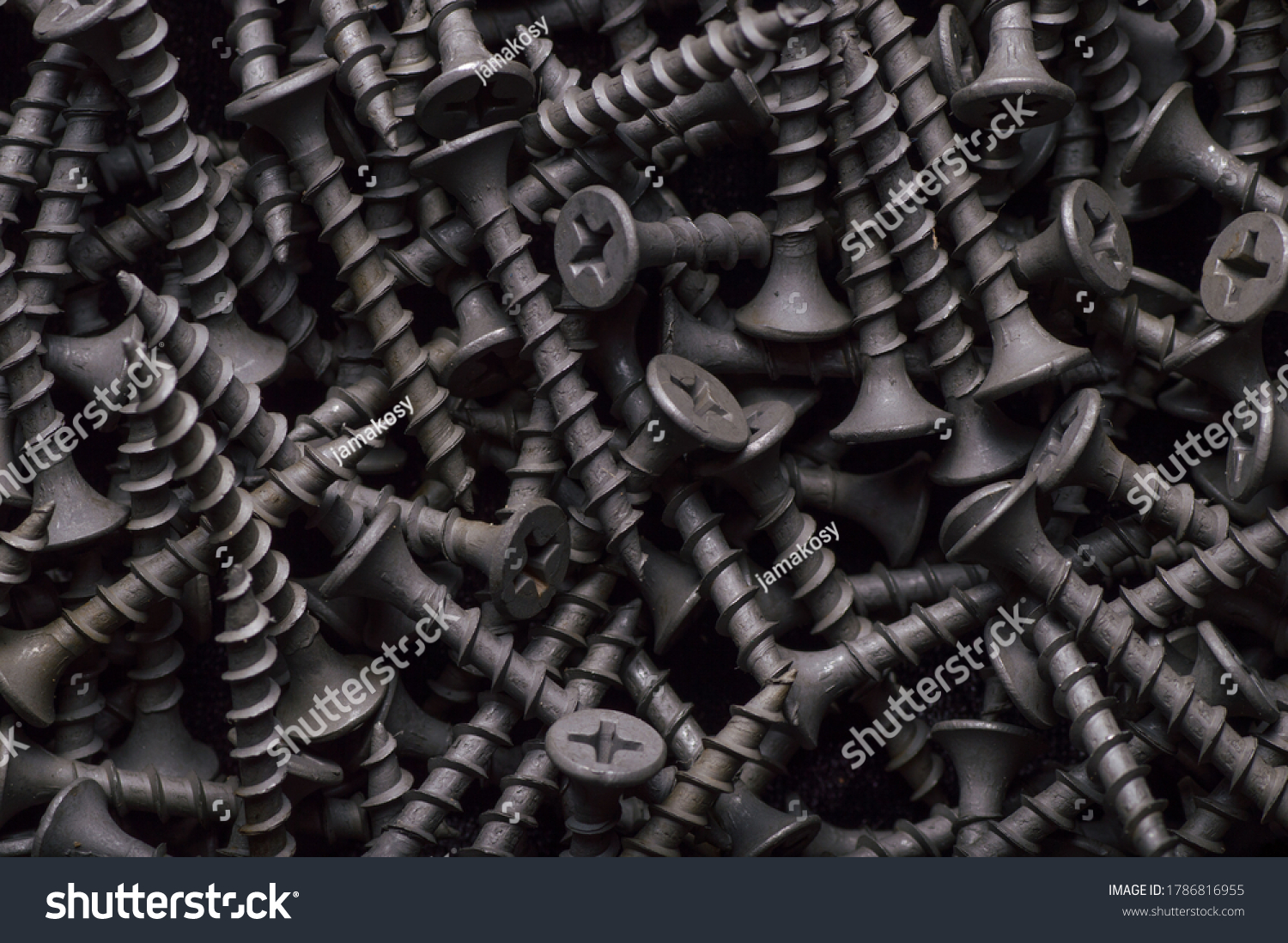 Black steel self-tapping screws used in handicrafts background texture #1786816955