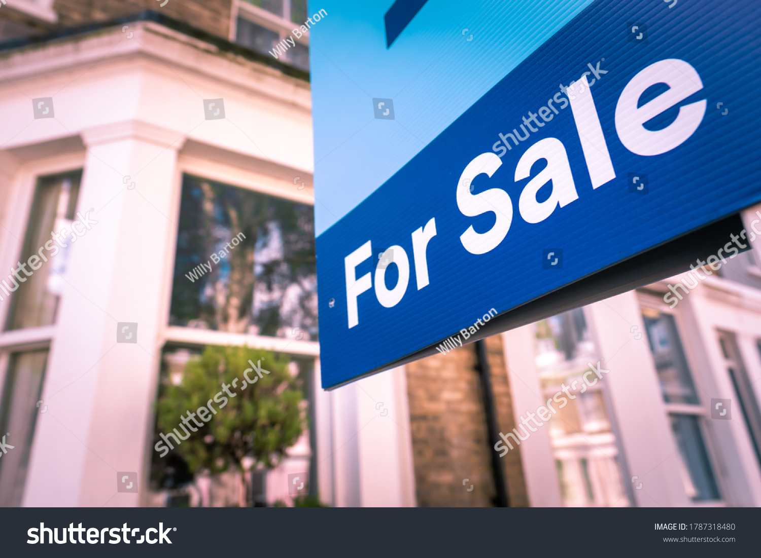 Estate agent For Sale sign on street of houses #1787318480