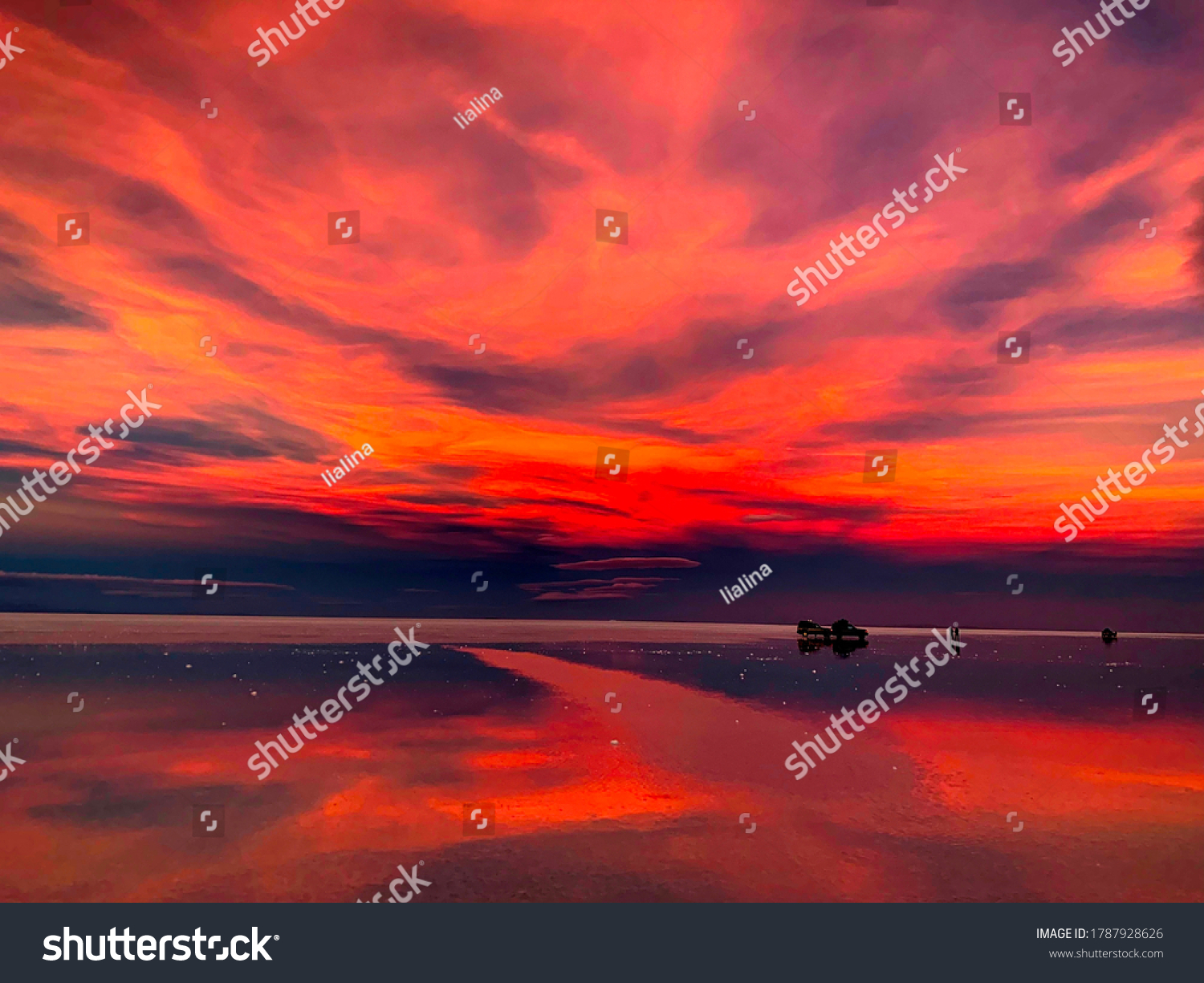 Fiery red purple sunset over salt marsh in Salar de Uyuni,Bolivia. Stunning sunset sky.The Mars-like landscape of the world's largest salt flat. Surreal beautiful view evening playa Tunupa. Reflection #1787928626