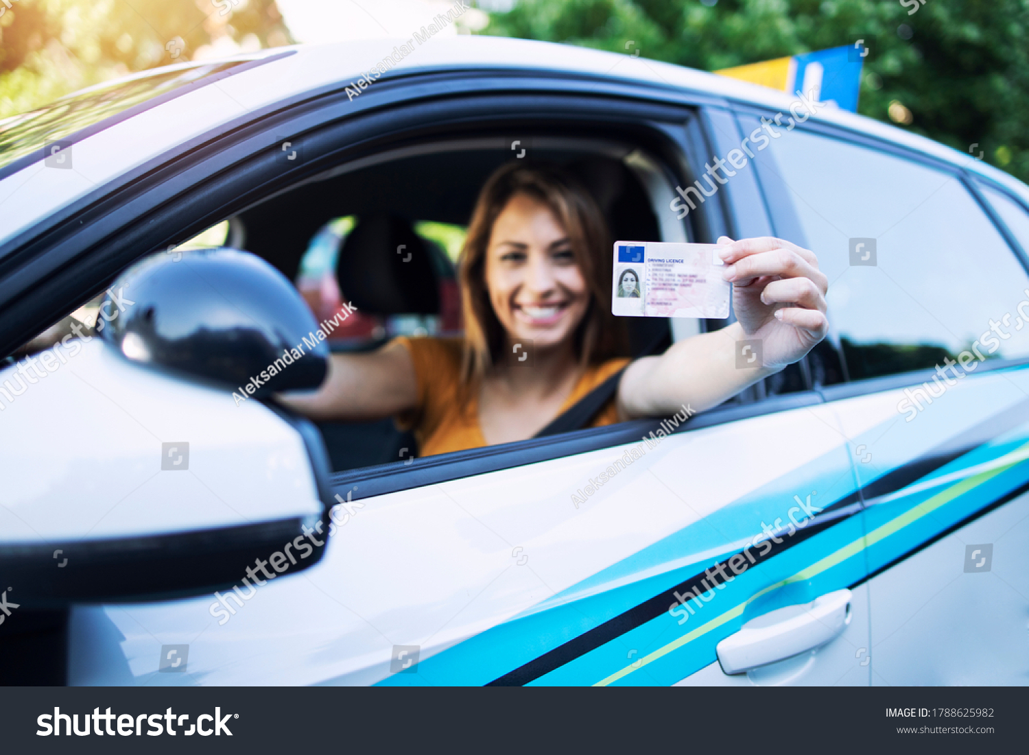 Woman with driving license. Driving school. Young beautiful woman successfully passed driving school test. Female smiling and holding driver's license. #1788625982
