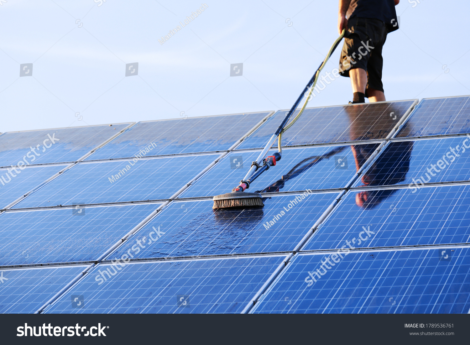 Cleaning solar panels with brush and water #1789536761