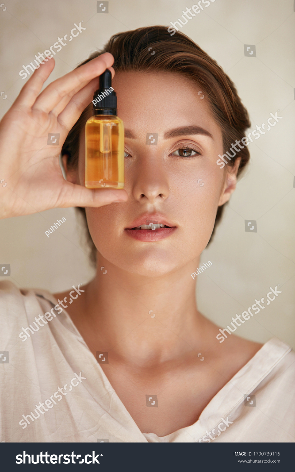 Skin Care. Beauty Portrait Of Woman Holding Bottle With Dropper Near Face. Model Using Natural Cosmetic Product For Hydrated, Glowing And Healthy Facial Derma. Essential Oil For Anti-Aging Therapy. #1790730116