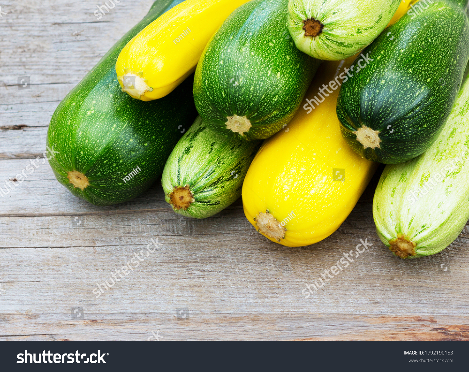 Zucchini on wooden background. Yellow and green zucchini. Vegetable marrow courgette or zucchini. Harvest courgette organic ingredient. #1792190153