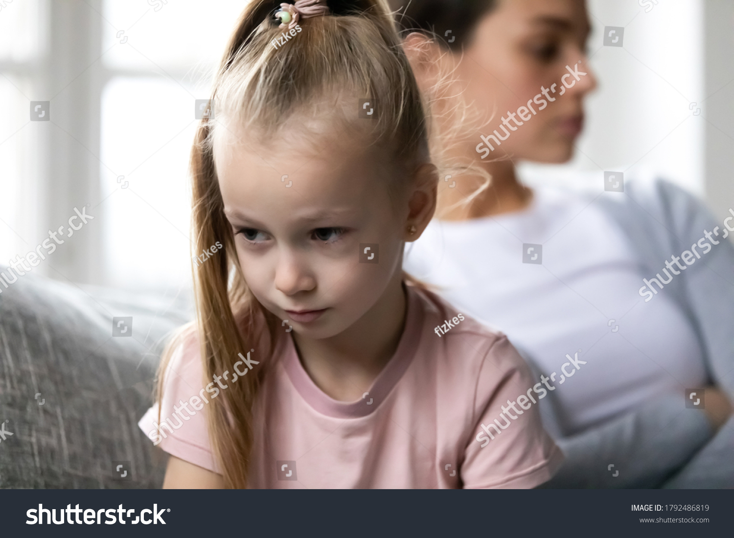 Close up head shot unhappy offended little blonde child girl turning away from upset mother, feeling stressed after quarrel or misunderstanding, family conflict, different generations gap concept. #1792486819
