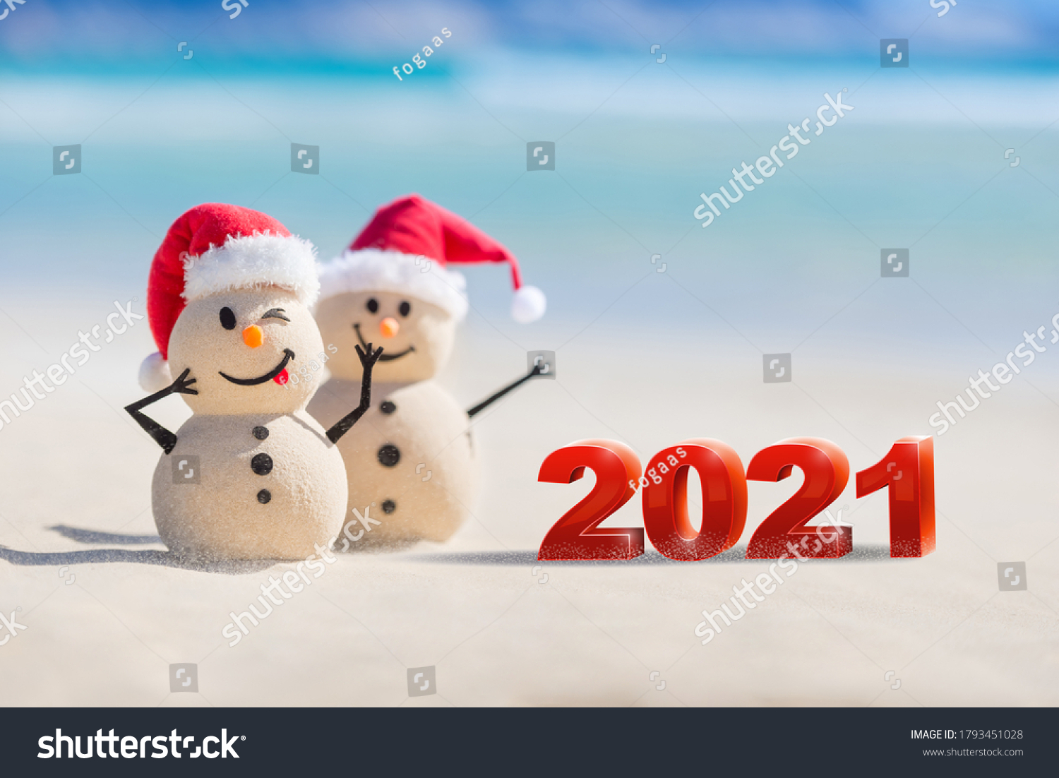 Two Sandy Christmas Snowmen are celebrating a Happy New Year on a beautiful beach with 2021 3d text, concept for new year 2021 #1793451028