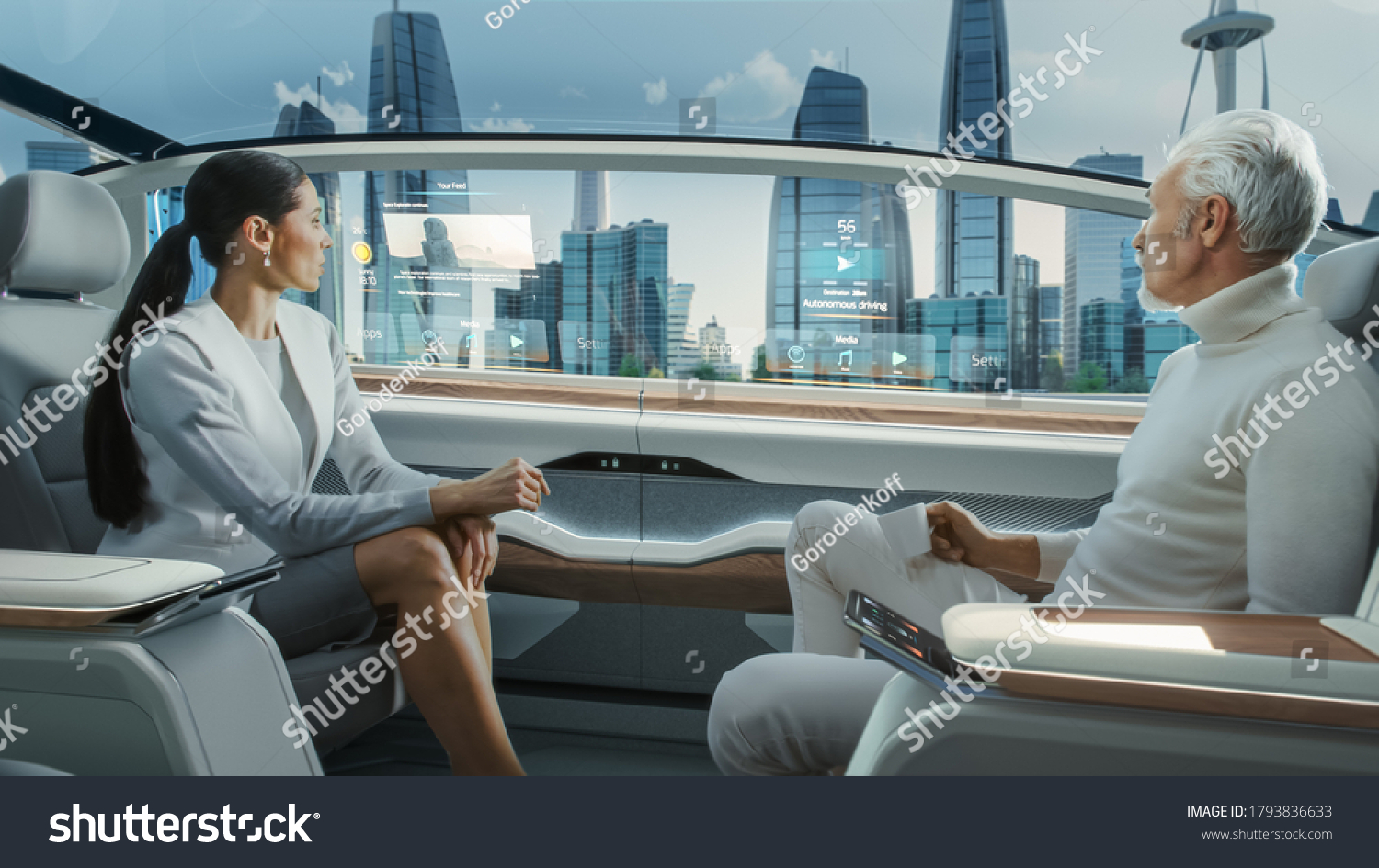 Beautiful Female and Senior Man are Having a Conversation in a Driverless Autonomous Vehicle. Futuristic Self-Driving Van is Moving on a Public Highway in a Modern City with Glass Skyscrapers. #1793836633